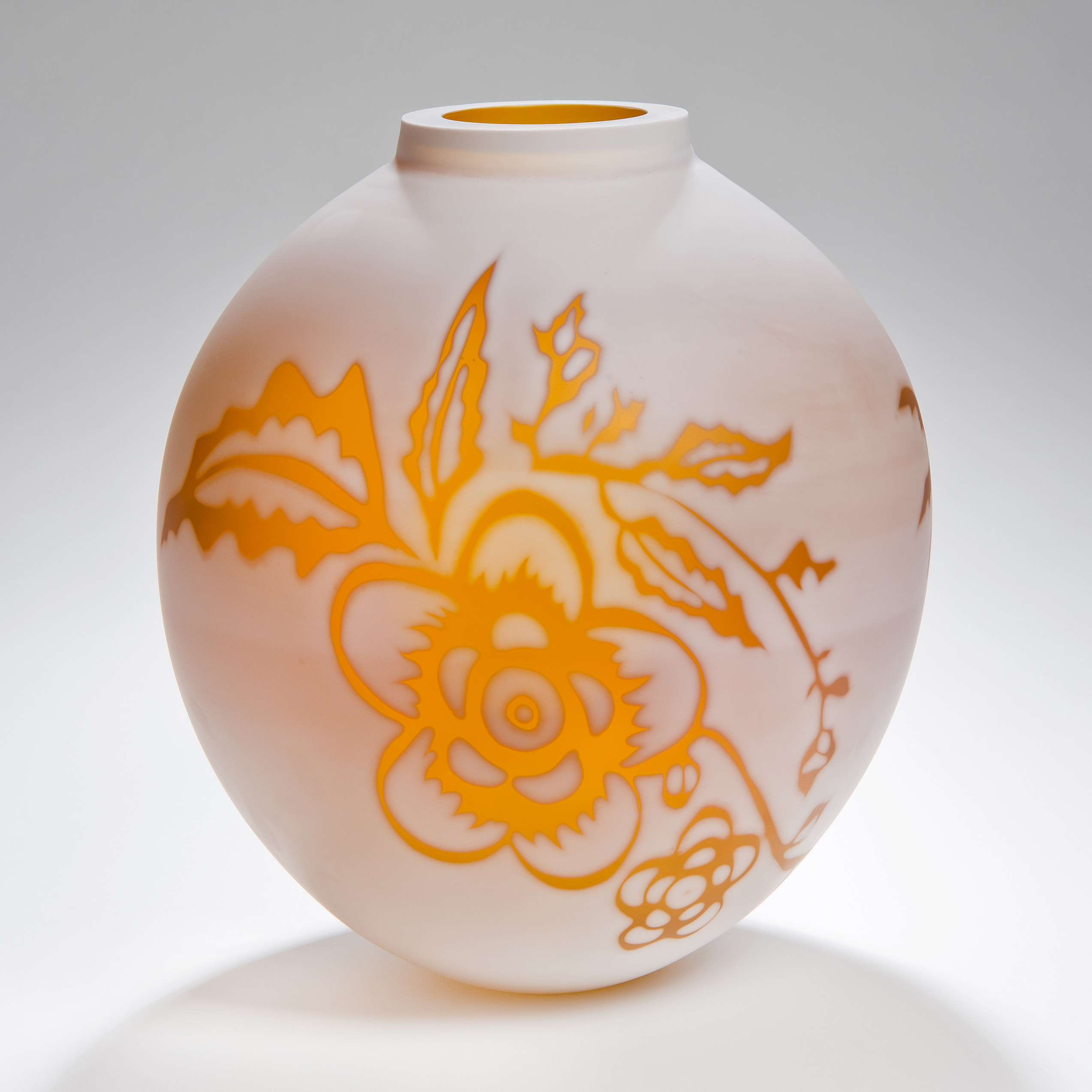 short round cameo glass vase in marble white with bright orange floral motif