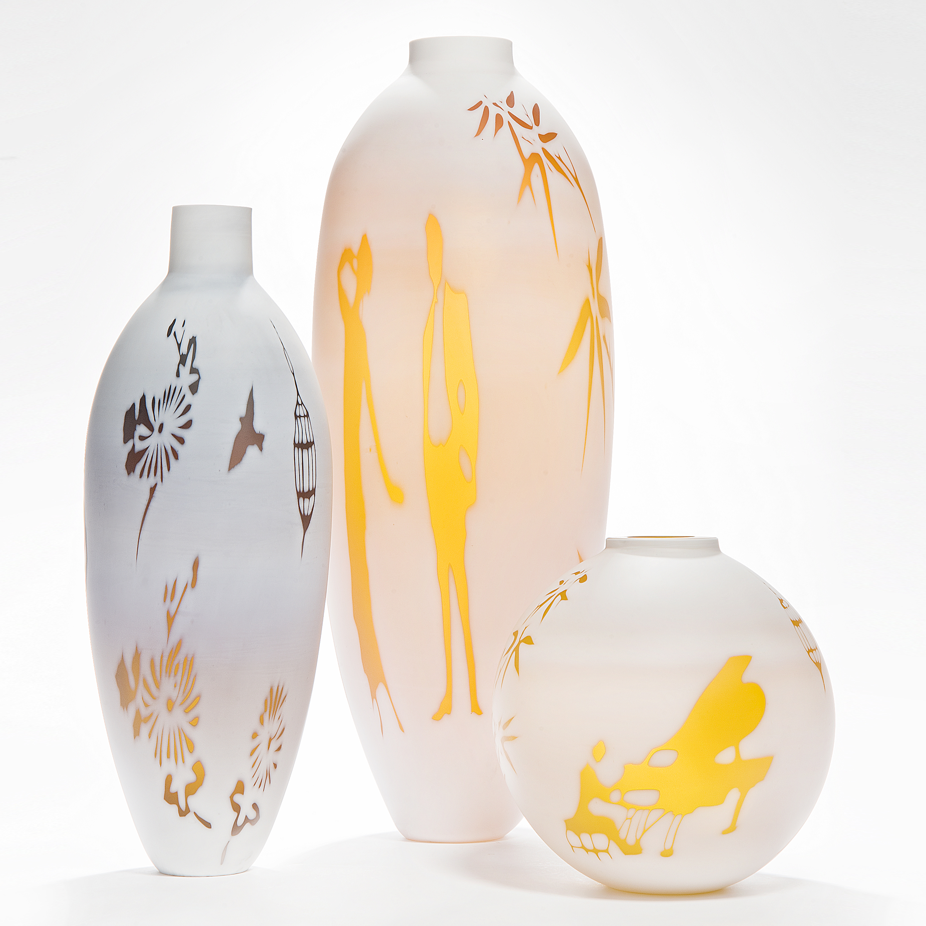cameo glass vases in white with bright orange and red motifs