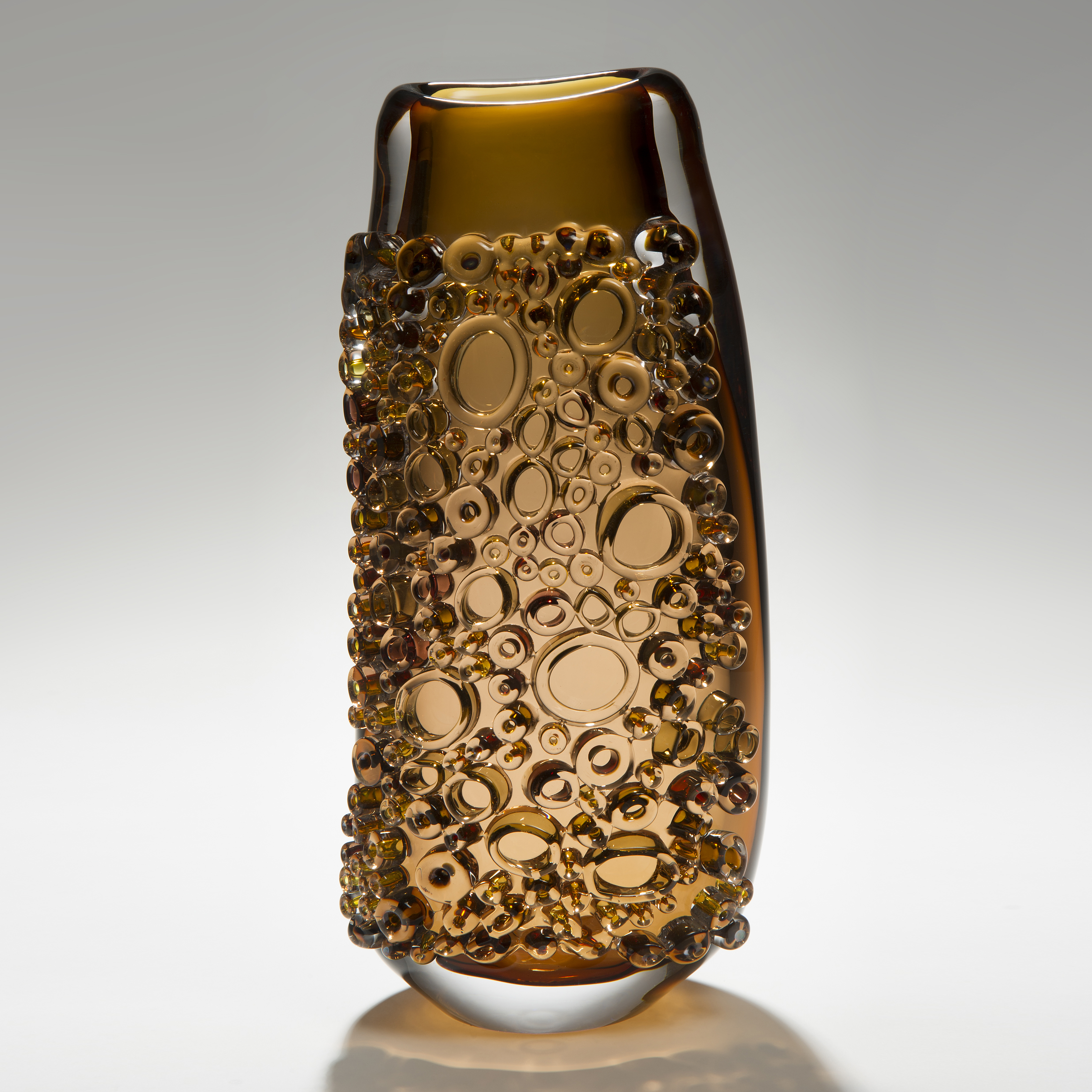 dark amber tall glass vessel sculpture with external circular crystals