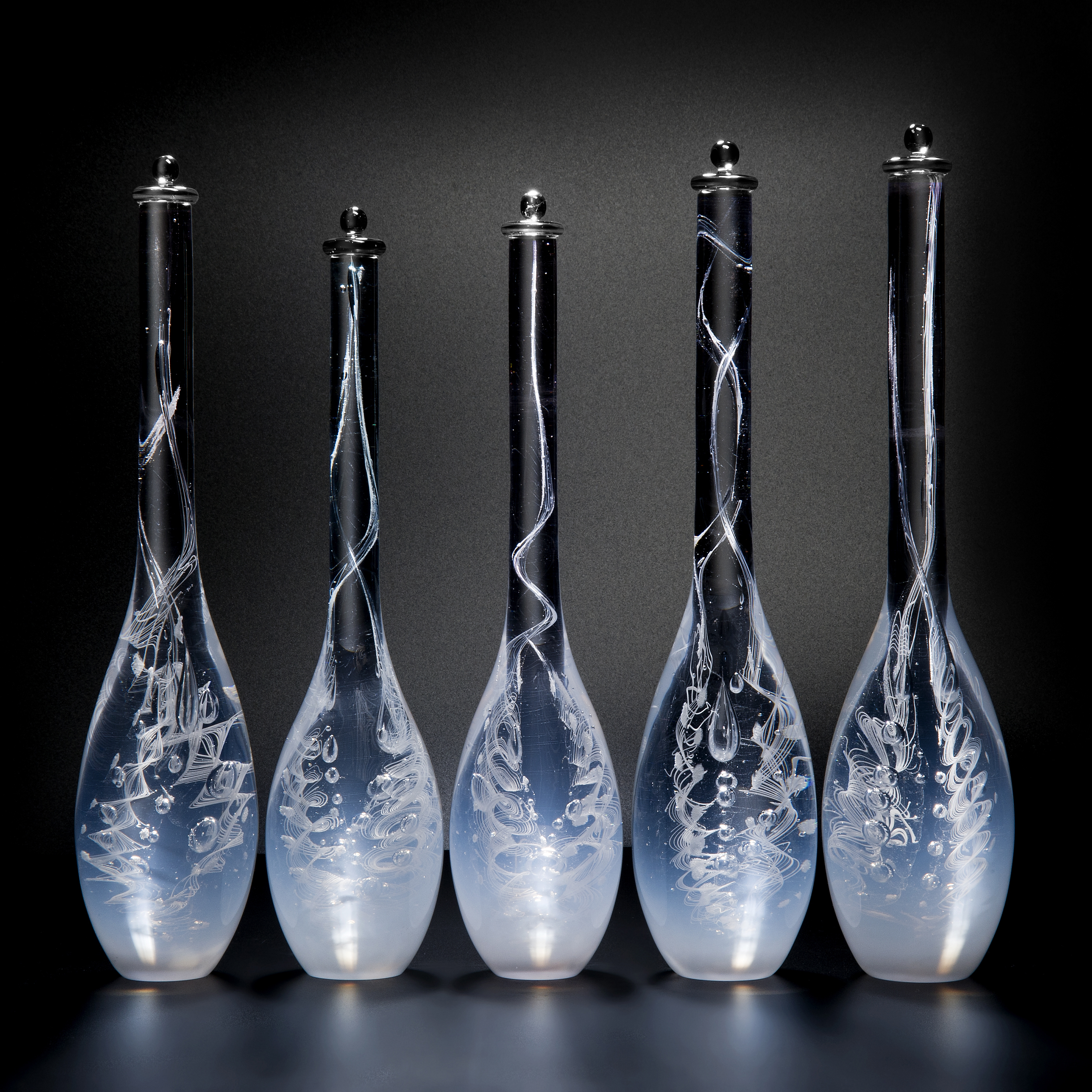 five blue art glass bottle sculptures with long necks