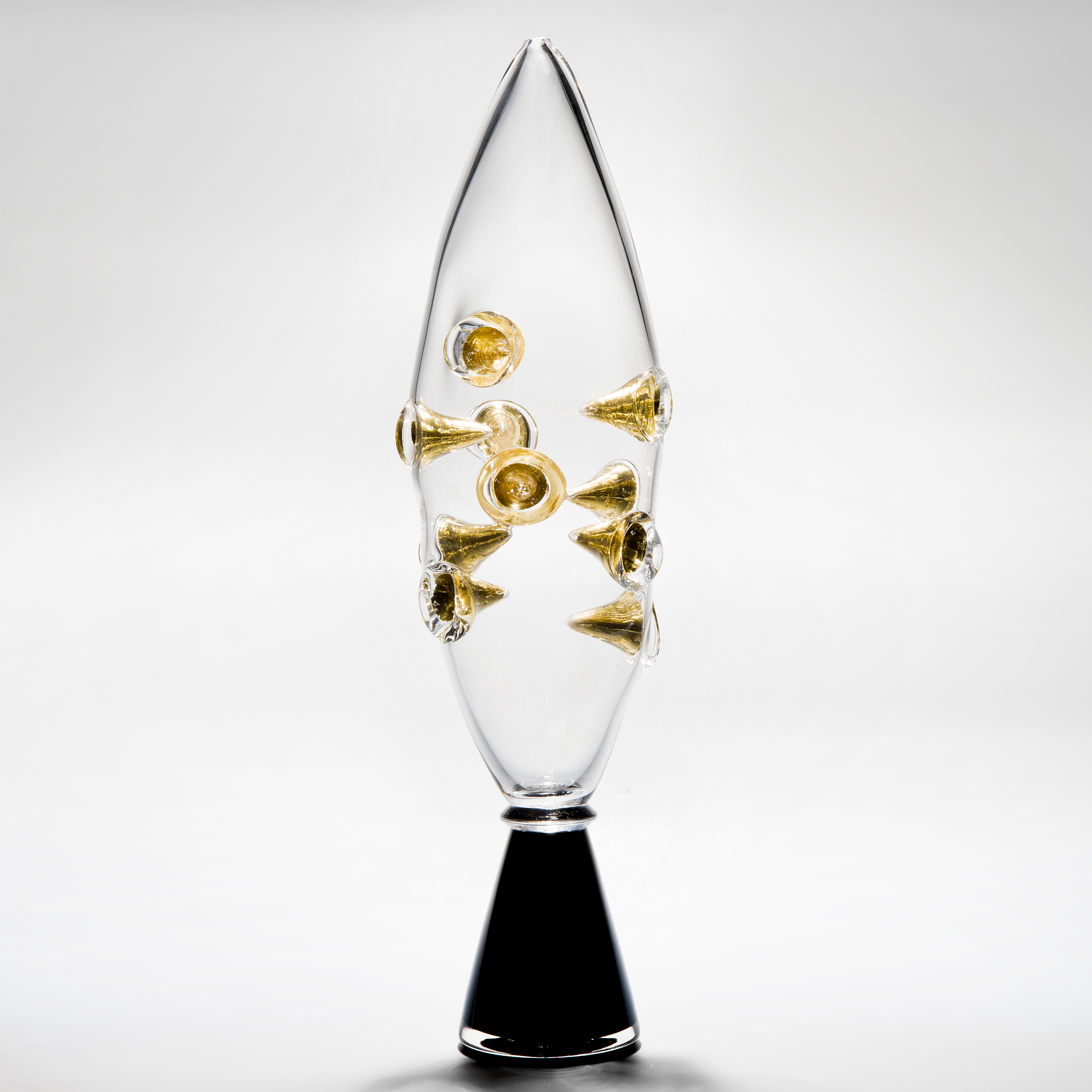 clear art glass vase with black base and embedded gold shards