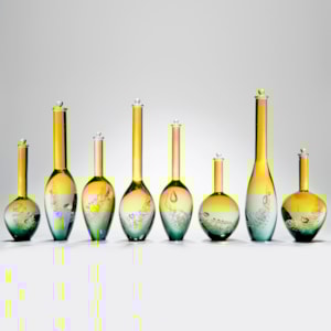 collection of eight handblown yellow and aqua glass vase sculptures with long necks in different sizes