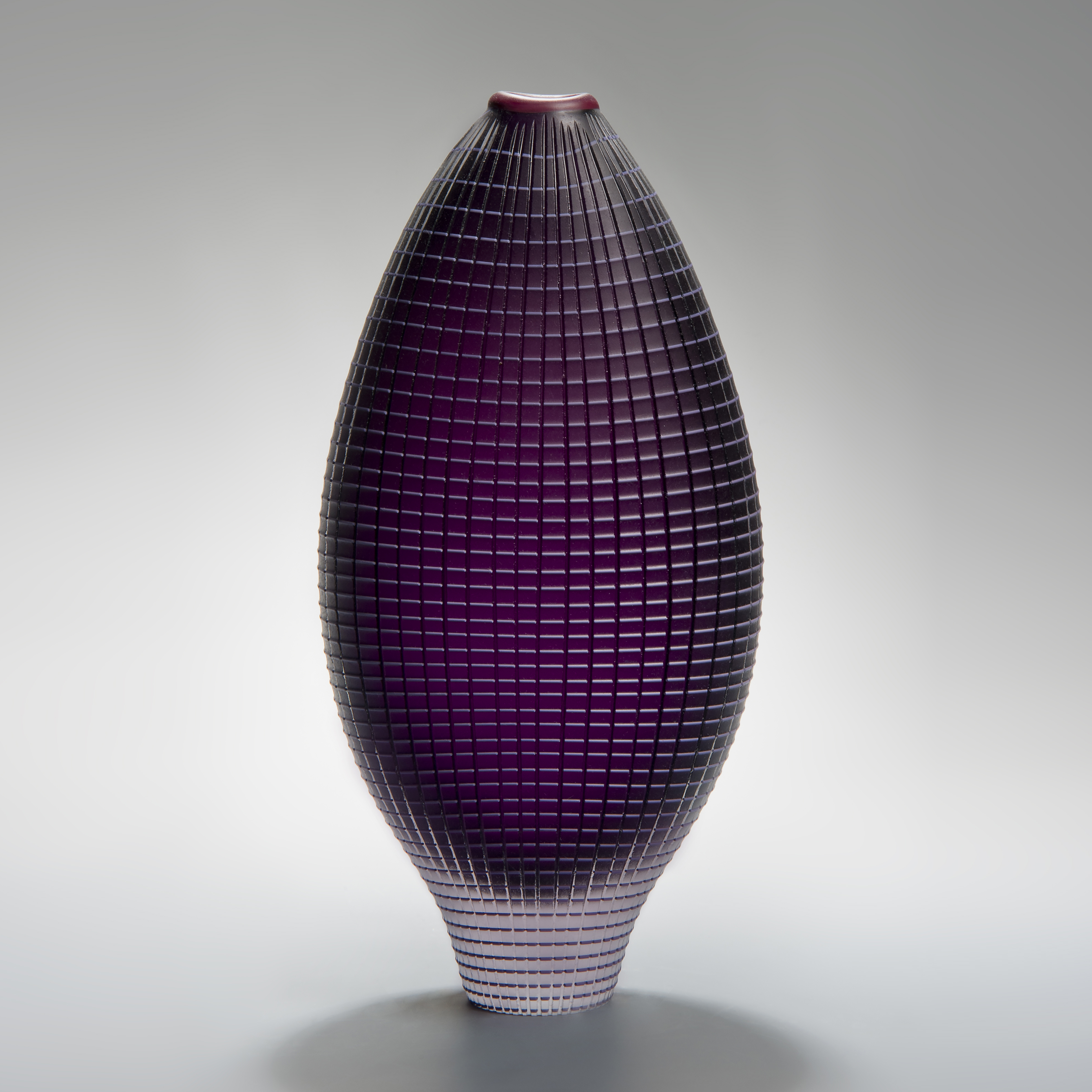 tall and wide handblown glass vase in dark purple with chequered external pattern