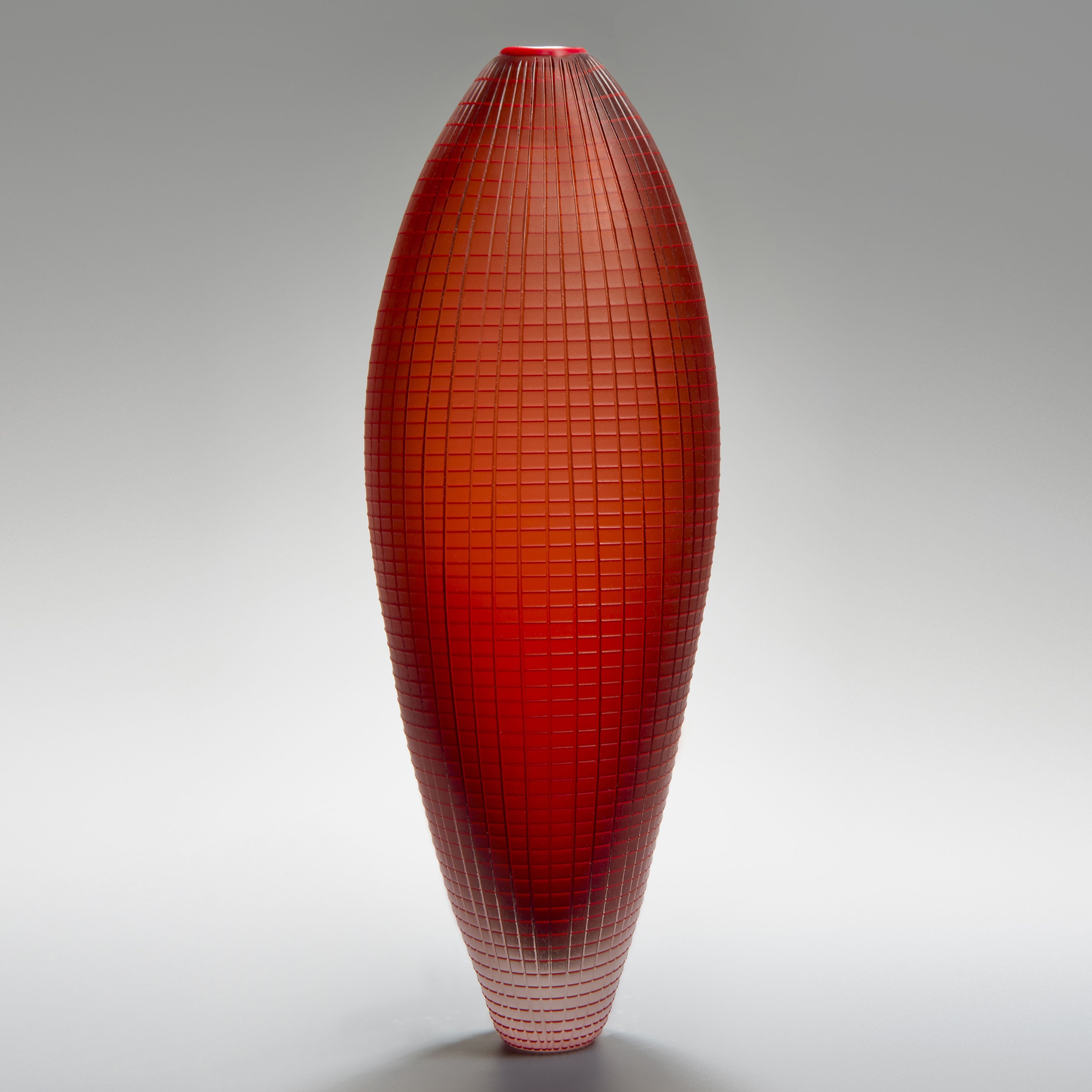tall oblong blown glass vase sculpture in orange and red with subtle checked pattern