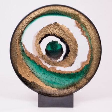 round art glass sculpture of eye like shape in white sand and green