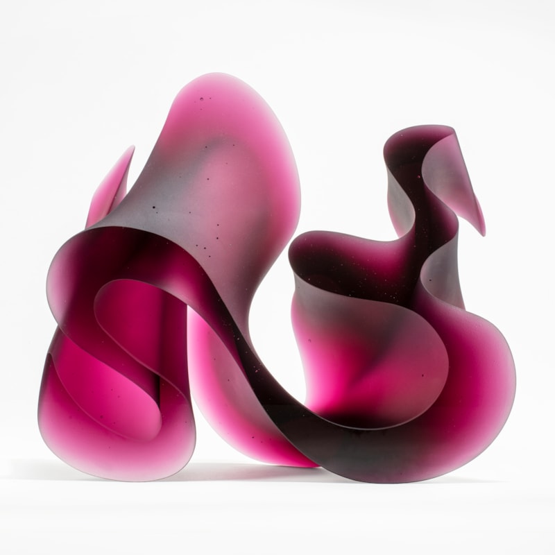 abstract geometric contemporary glass sculpture of squiggle in pink and black