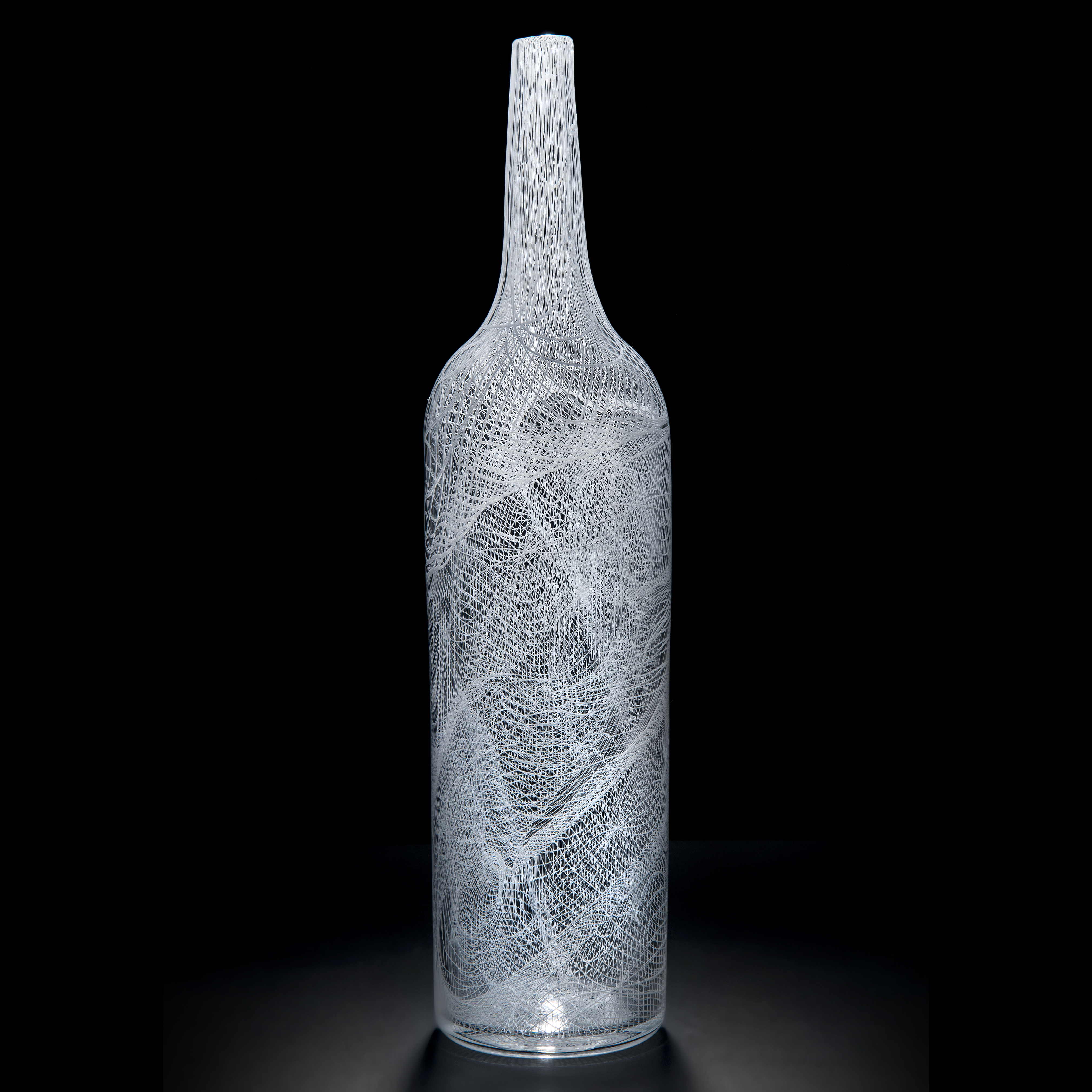tall art glass bottle with intricate cane pattern