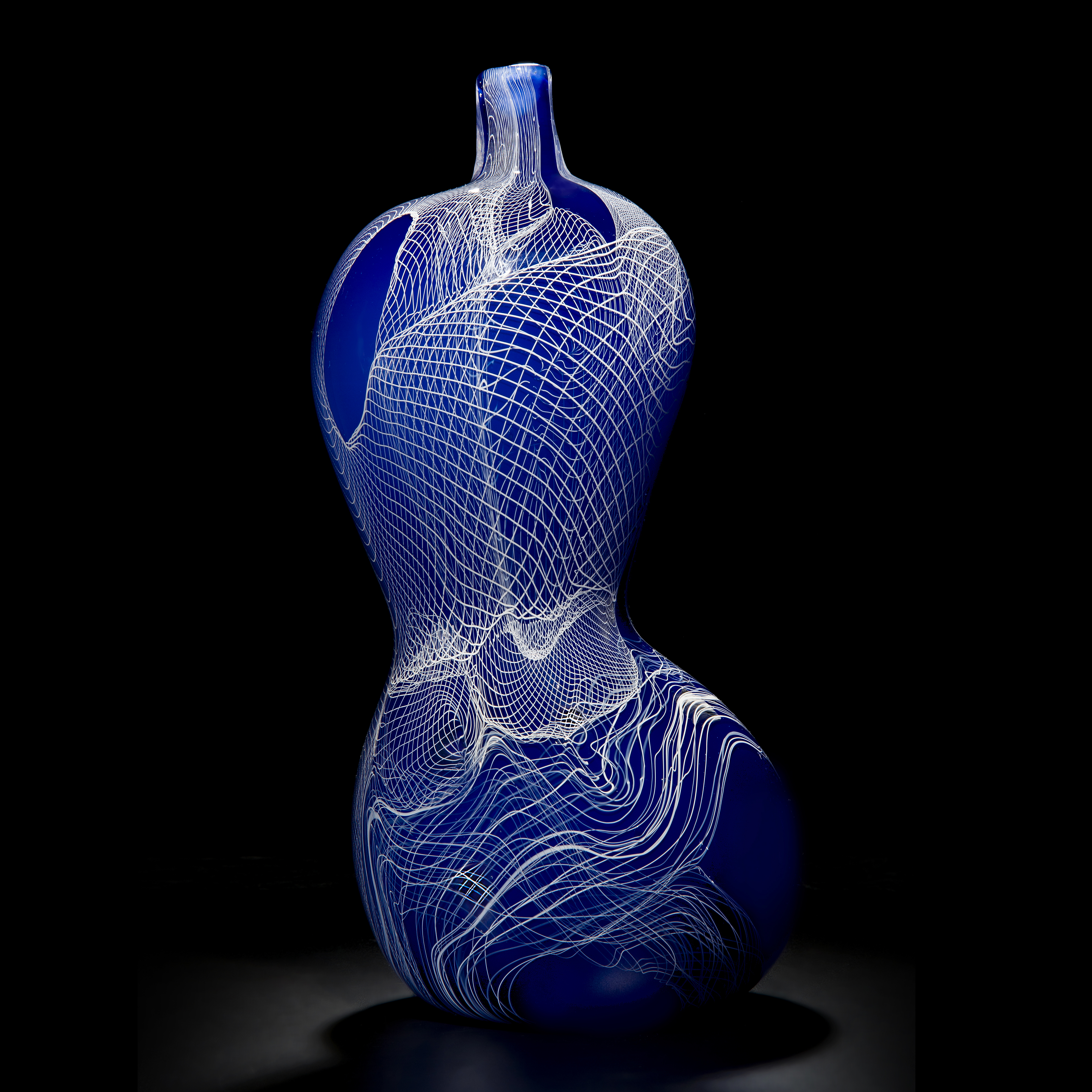 blue mouth blown curved shape glass vase with white cane line pattern