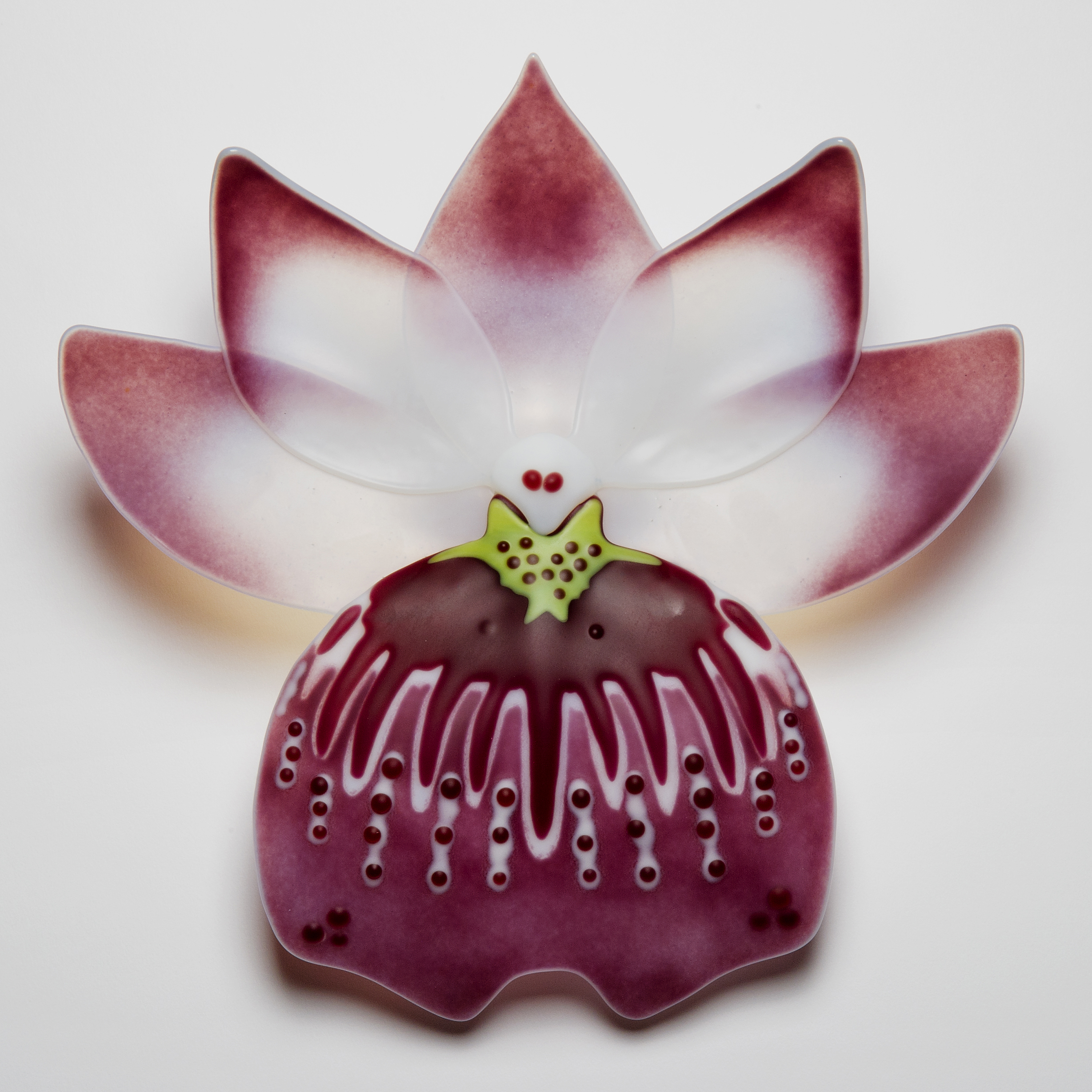 handmade fused glass sculpture of cranberry and pansy in white with purple edges
