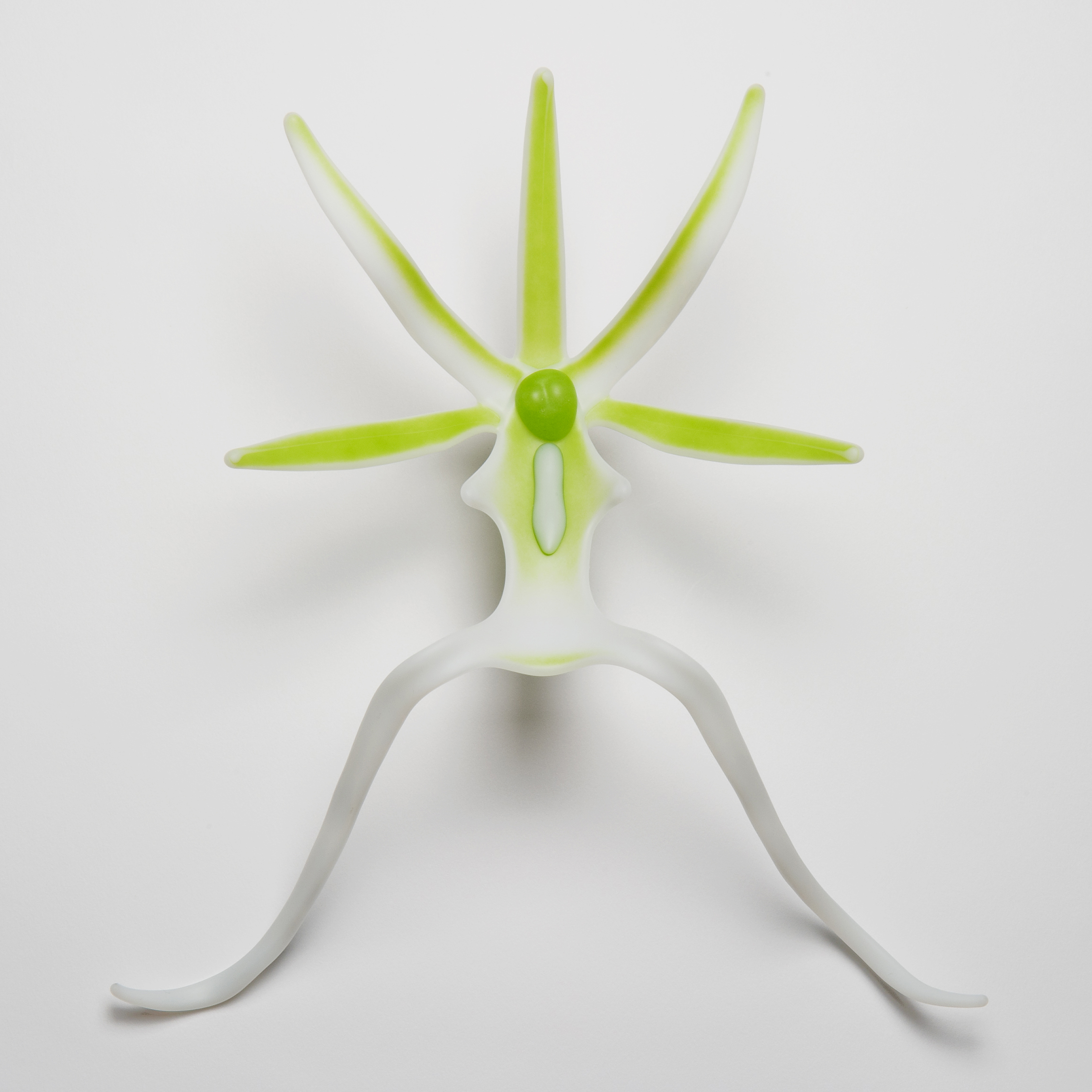 glass sculpture of ghost orchid in white and neon green