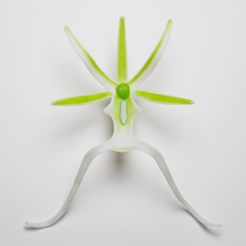 glass sculpture of ghost orchid in white and neon green