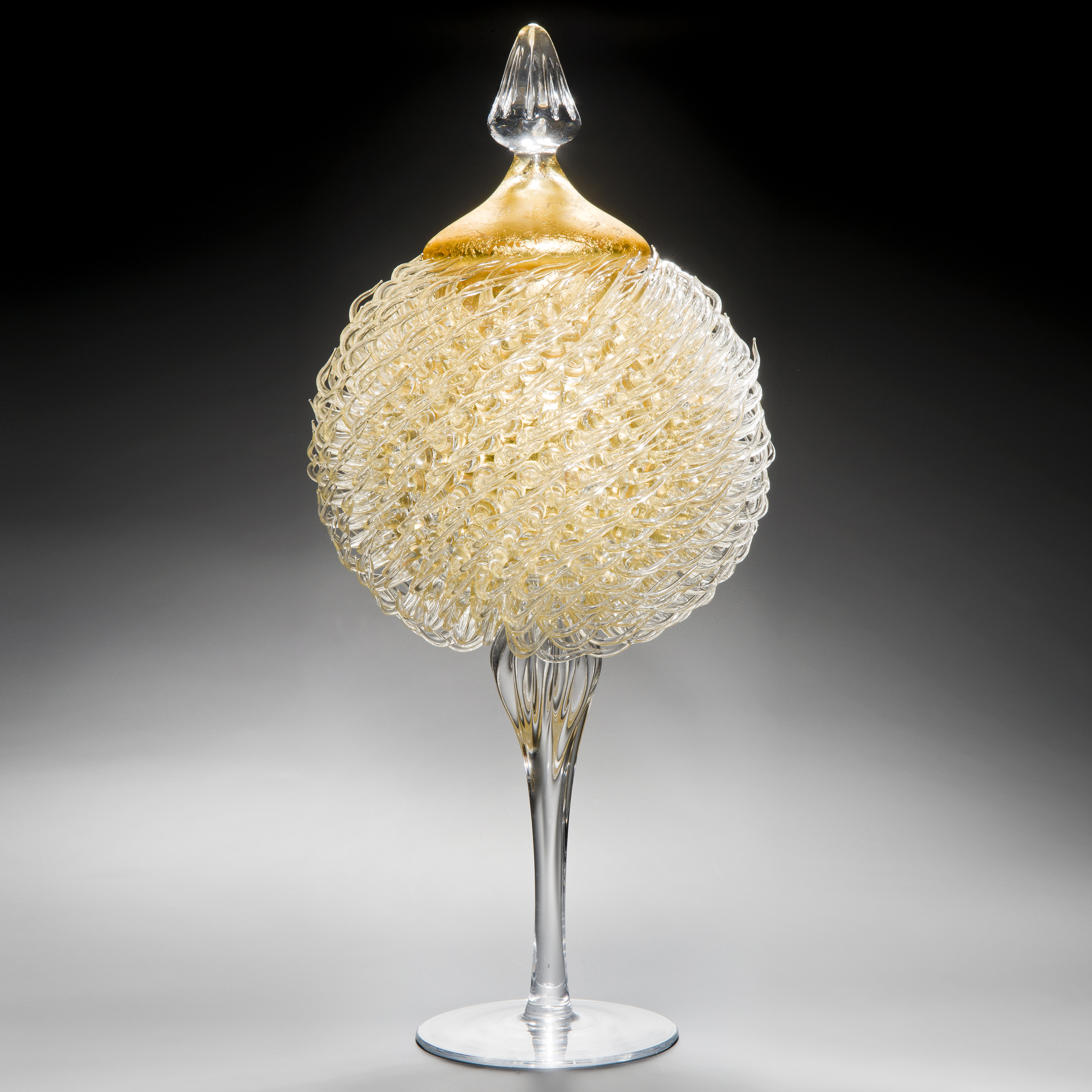 tall art glass jar sculpture with long base and gold thistle body