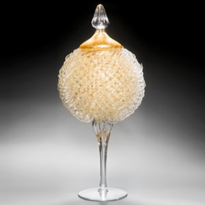 tall art glass jar sculpture with long base and gold thistle body