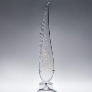 tall thin black art glass sculpture in the shape of a feather with hand chipped exterior gold patterns