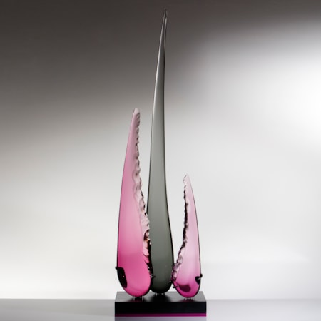 abstract sculpted glass artwork of three long glass shards one long black in the centre and two shorter in purple to either side