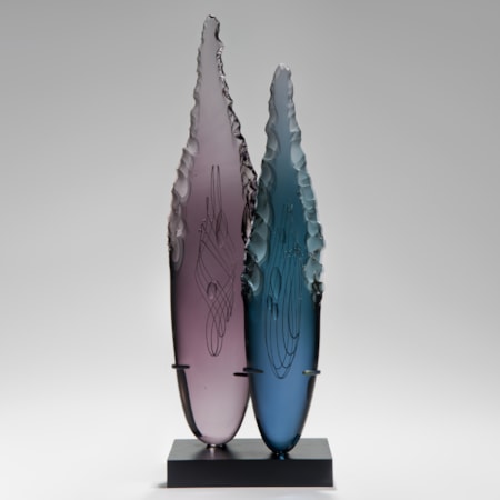 two plum and blue glass shard sculptures on black rectangular base
