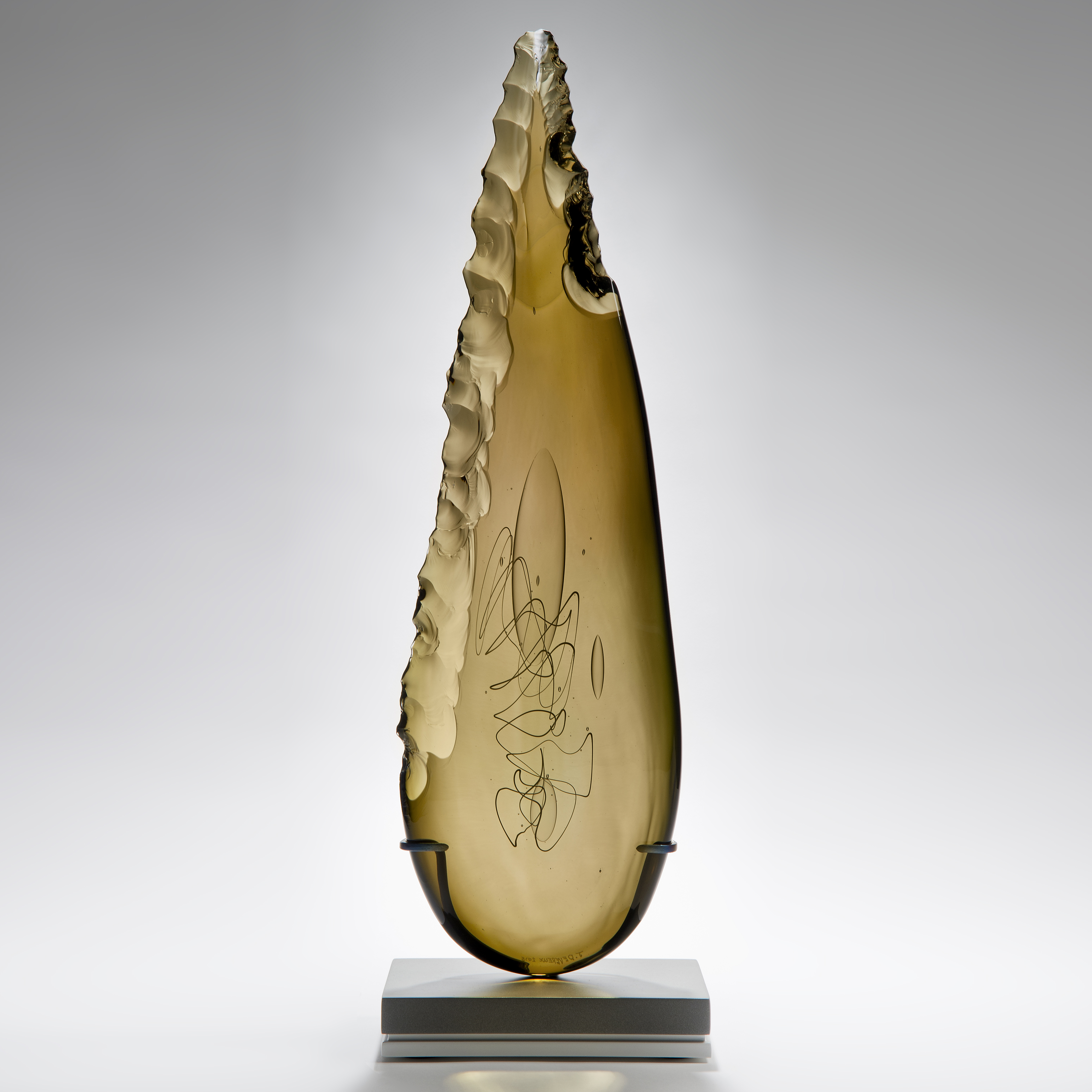 bronze leaf shaped art glass sculpture on grey base