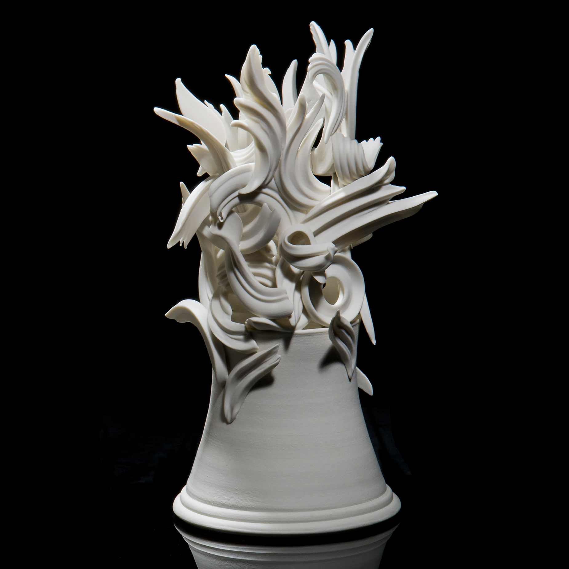 white ceramic sculpture of decorative architrave on potted base