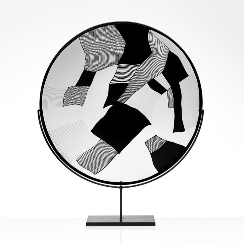 round modern glass art sculpture in black and white on steel stand