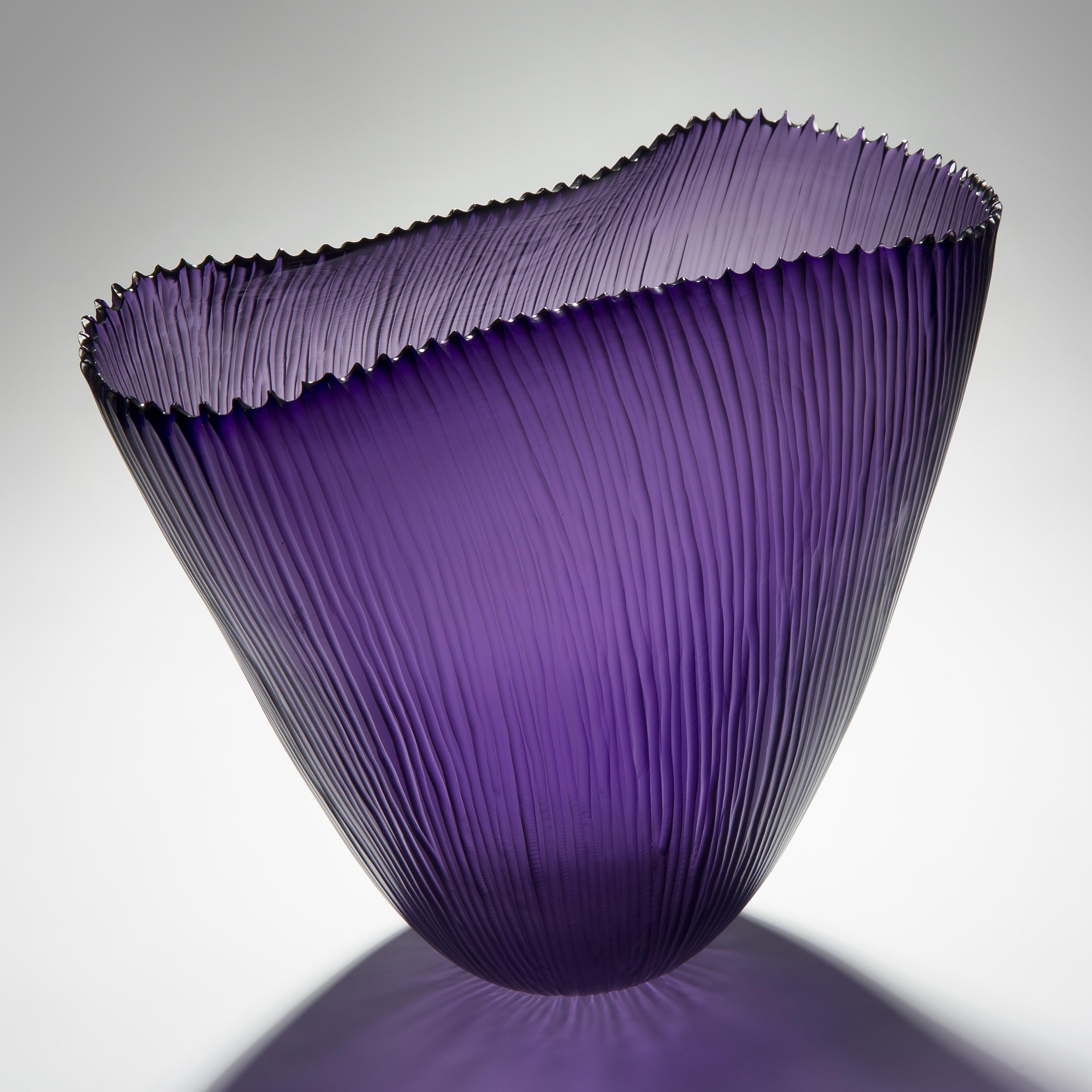 purple hand cut glass sculptre of wide open top basket with ribbed edge