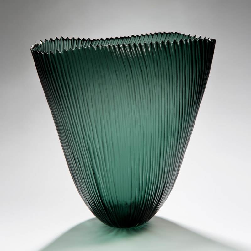 tall open sculpted green vessel with ribbed pattern
