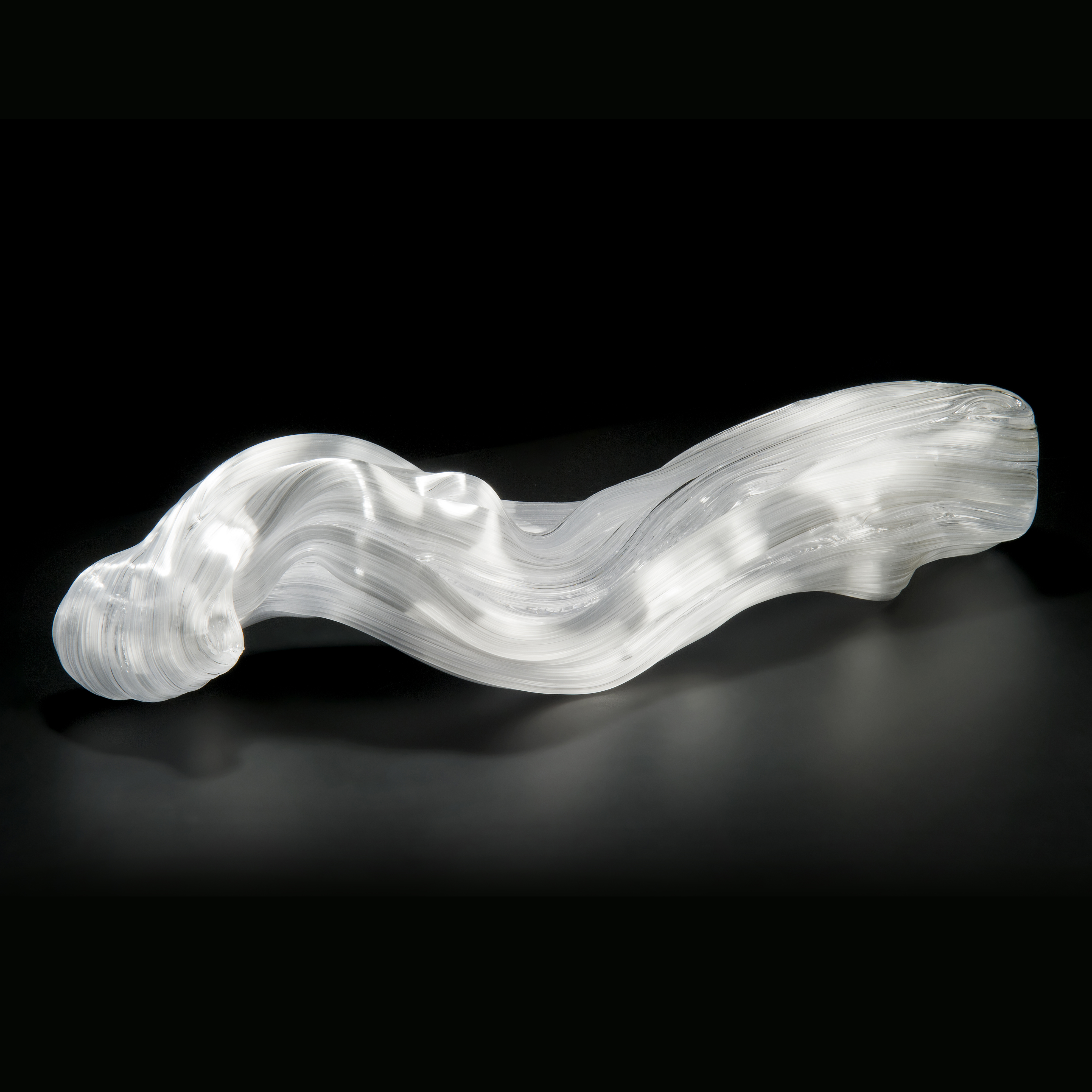 experimental art glass sculpture of long curved form in white