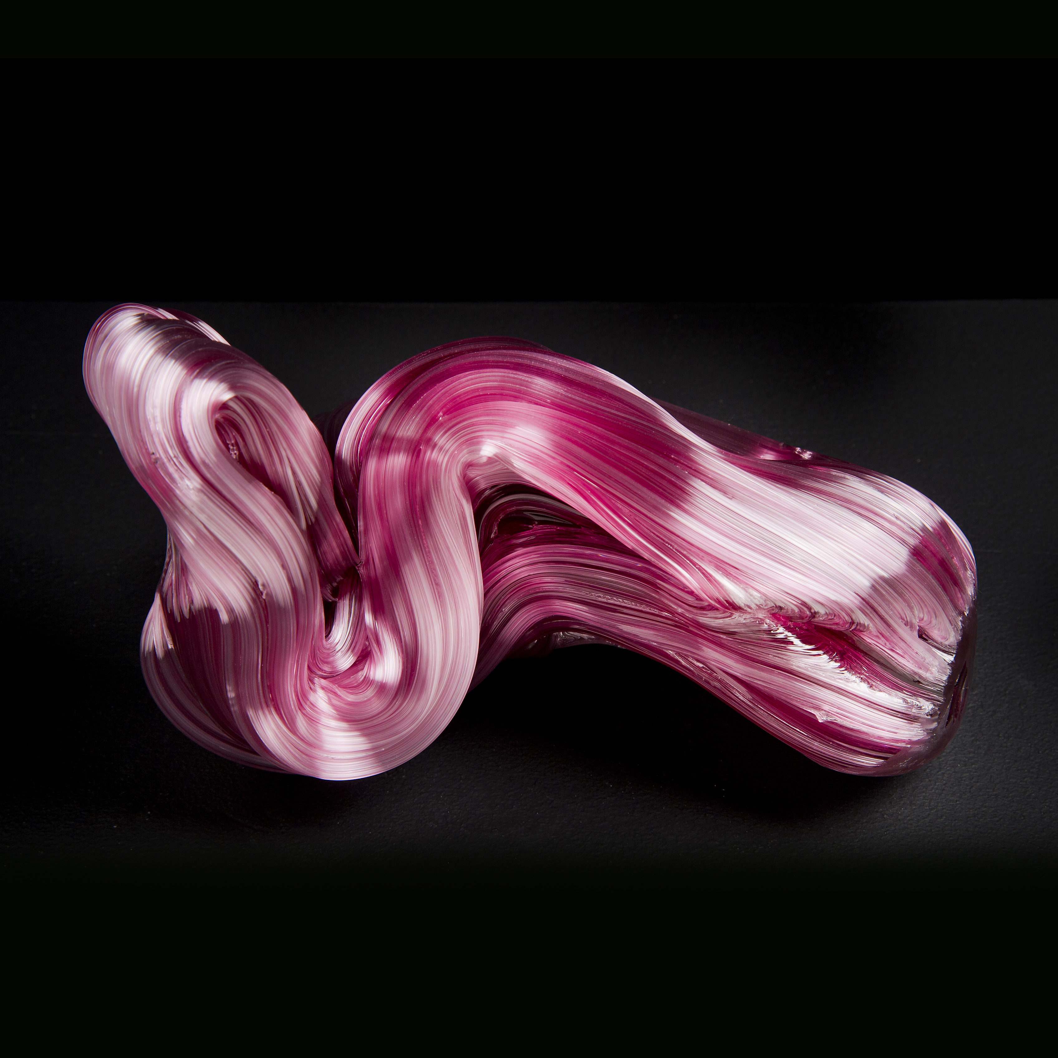 modern abstract horizontal decorative glass ornament of squiggly line in pink