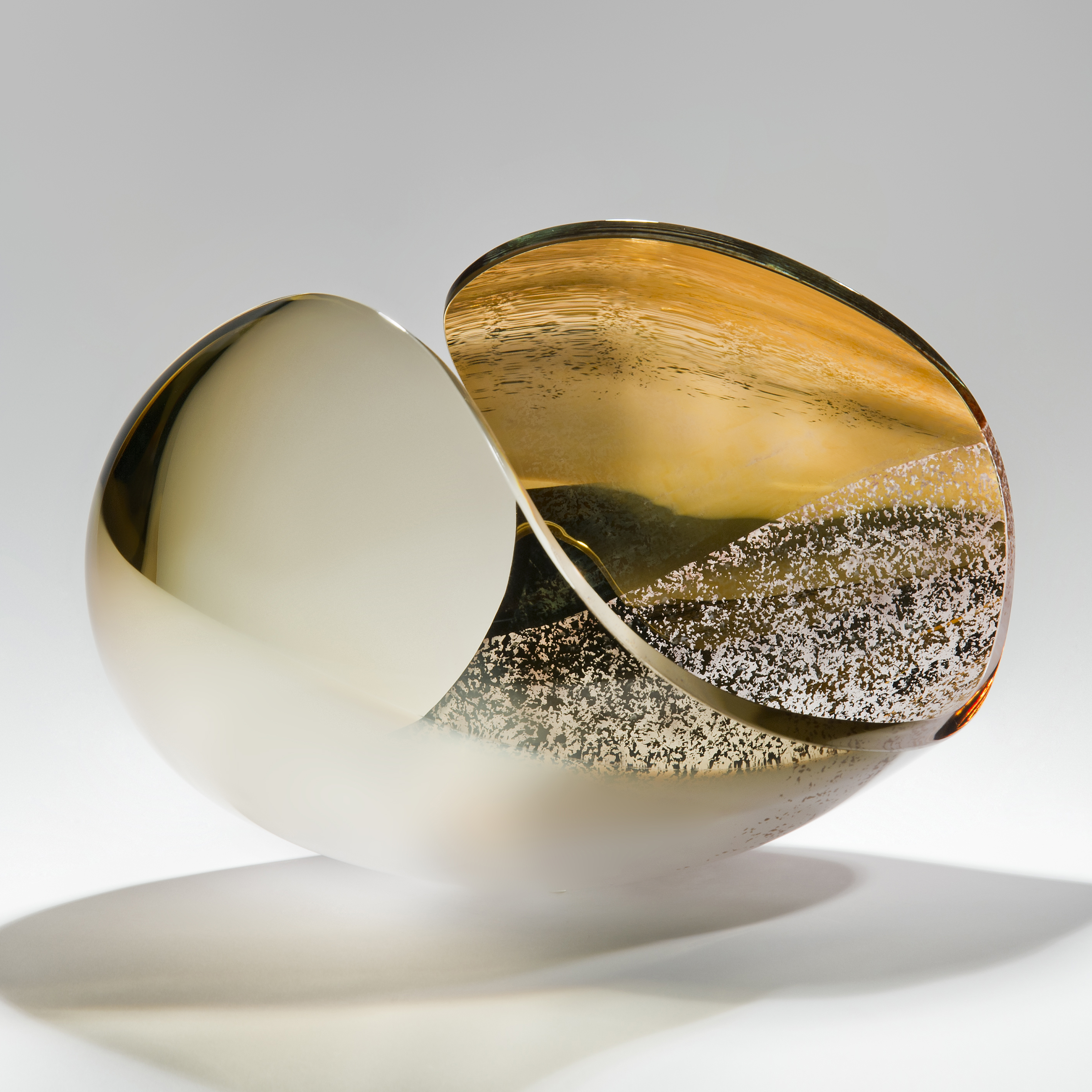detailed glass sculpture of concave shape in beige bone white and gold