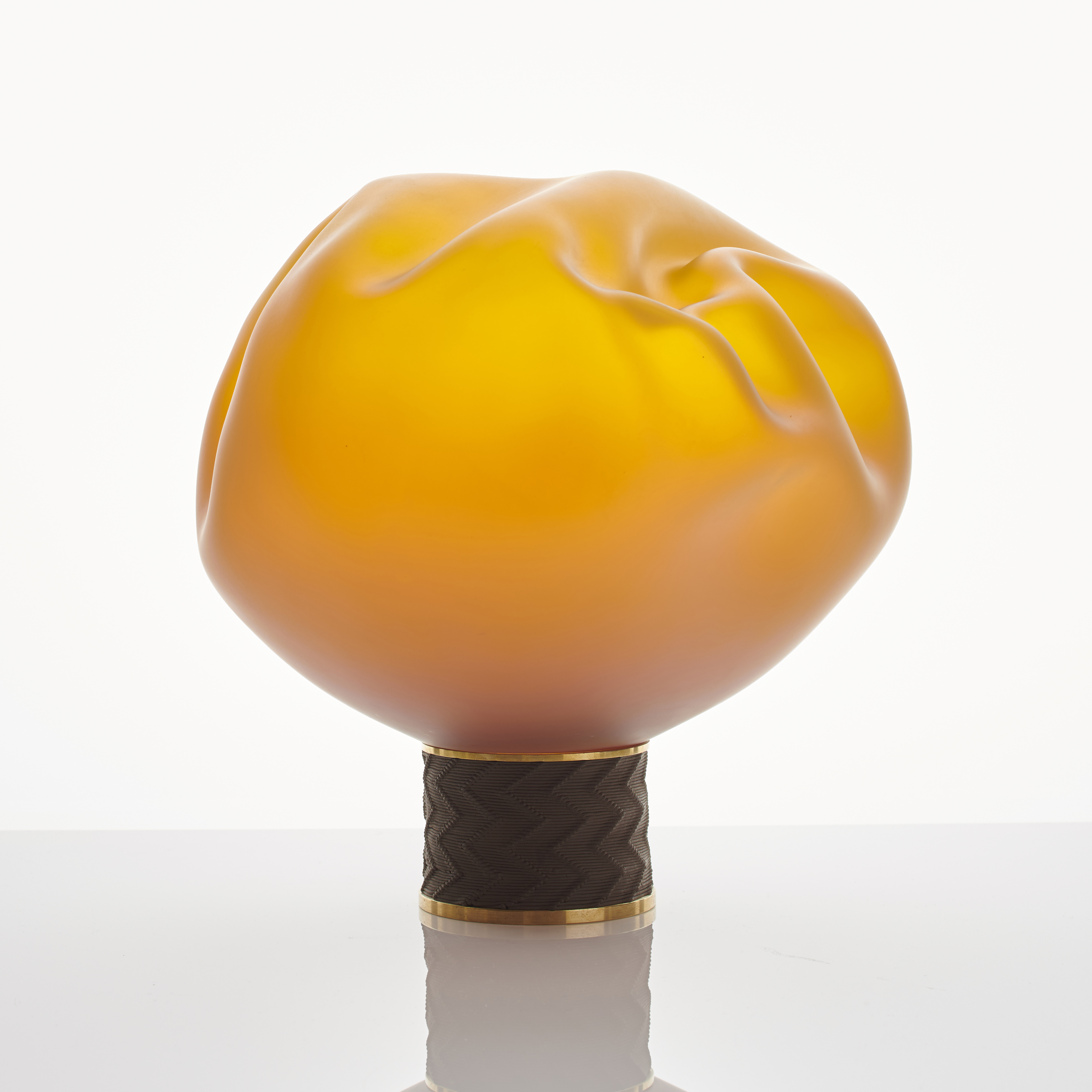 modern flower shaped art-glass sculpture in bright yellow and orange on brass base
