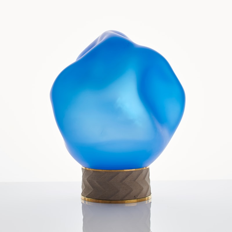 blue art glass sculpture of blob shaped blown glass top with bronze base