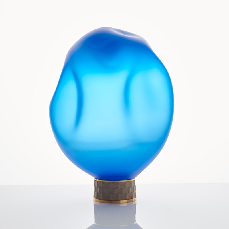 blue art glass sculpture of blob shaped blown glass top with bronze base