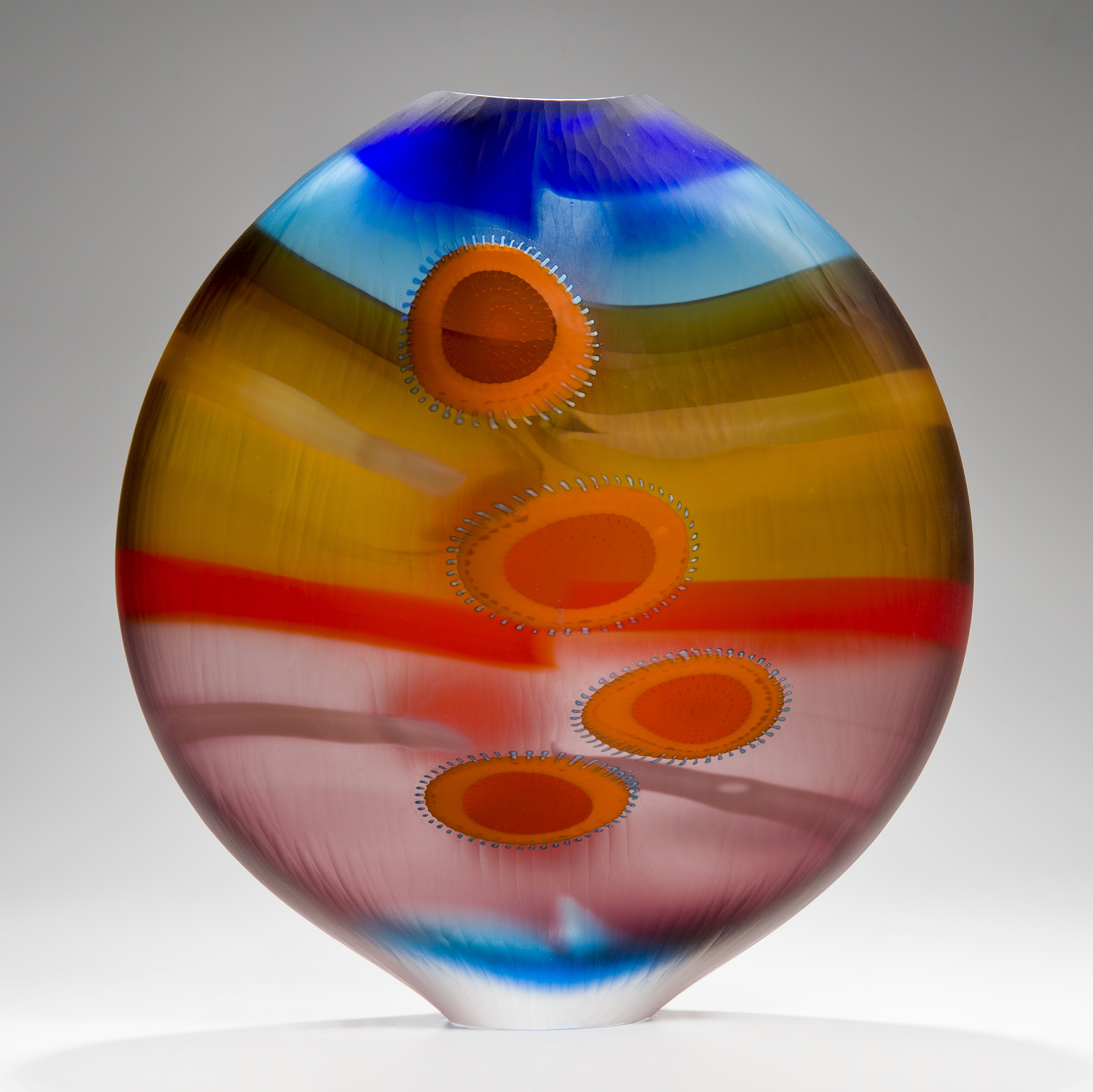 brightly coloured round glass vase with elliptical shapes