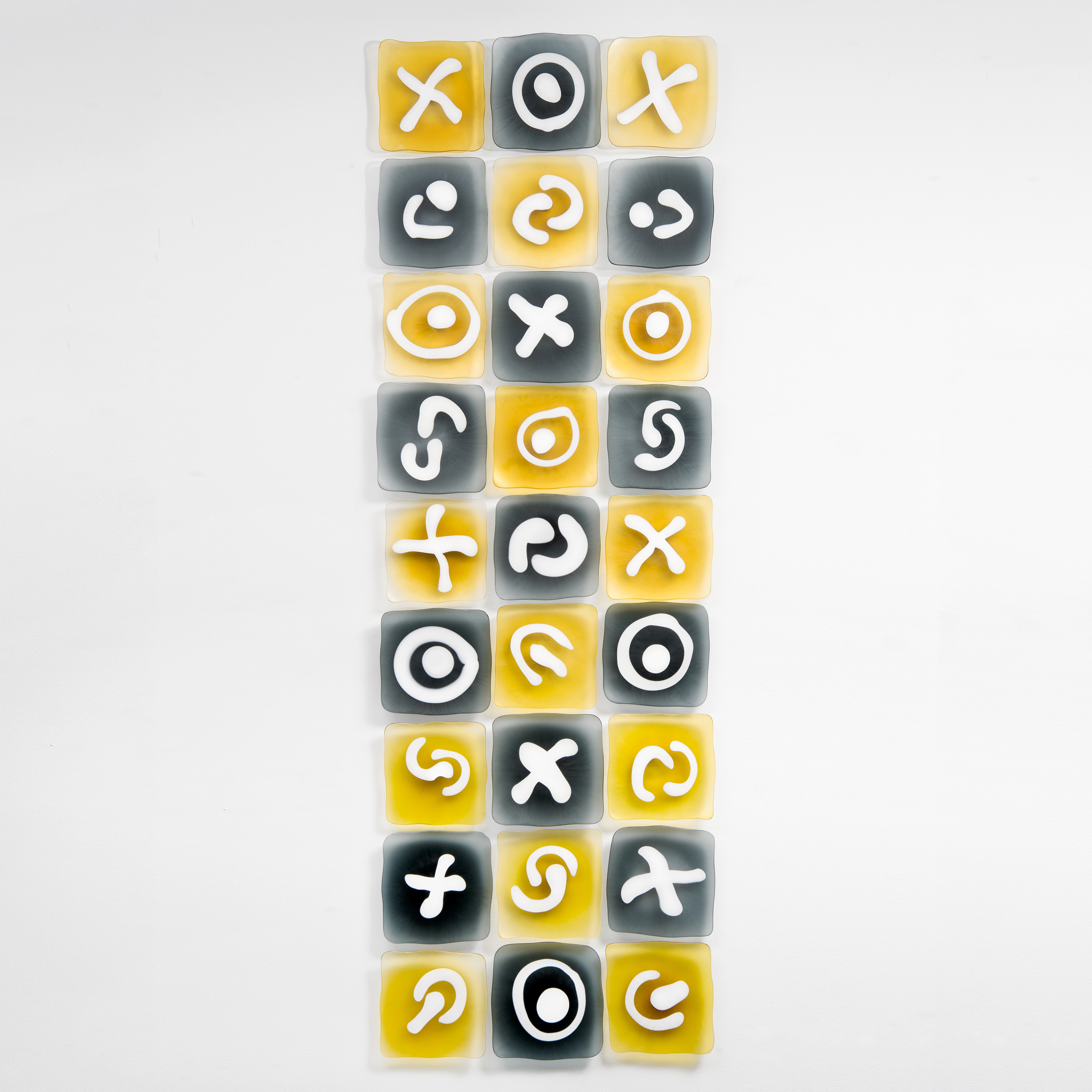 wall-mounted glass art sculpture resembling chocolate box in grey blue and gold