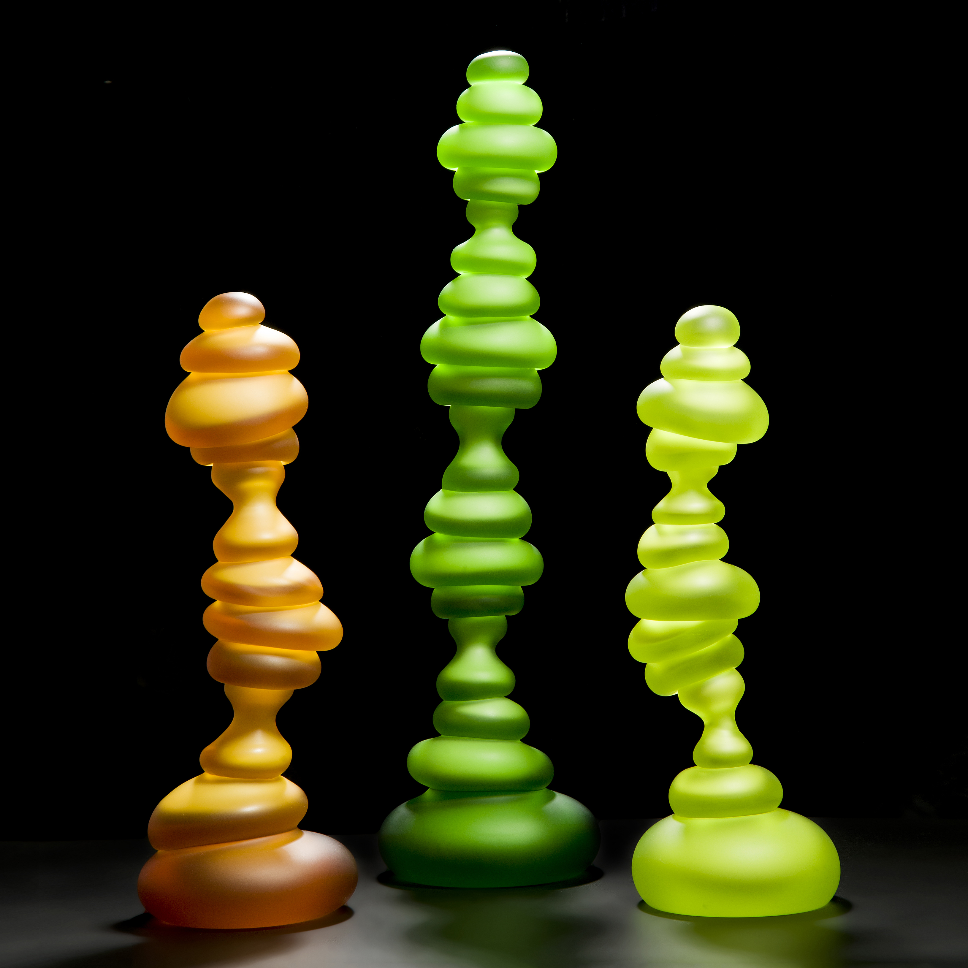 three tall neon blob shaped abstract art glass sculptures