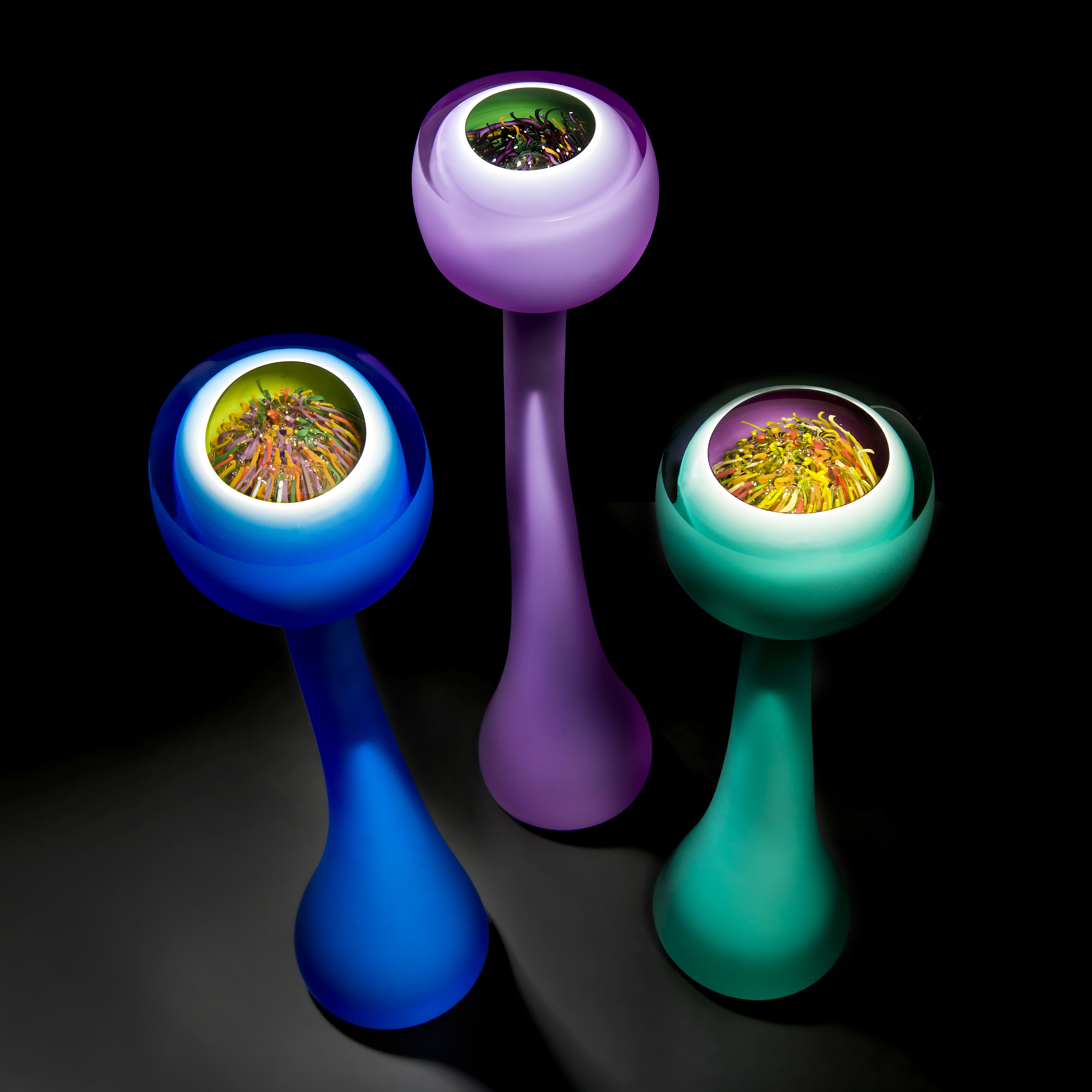 tall and thin pastel coloured abstract glass art sculptures 