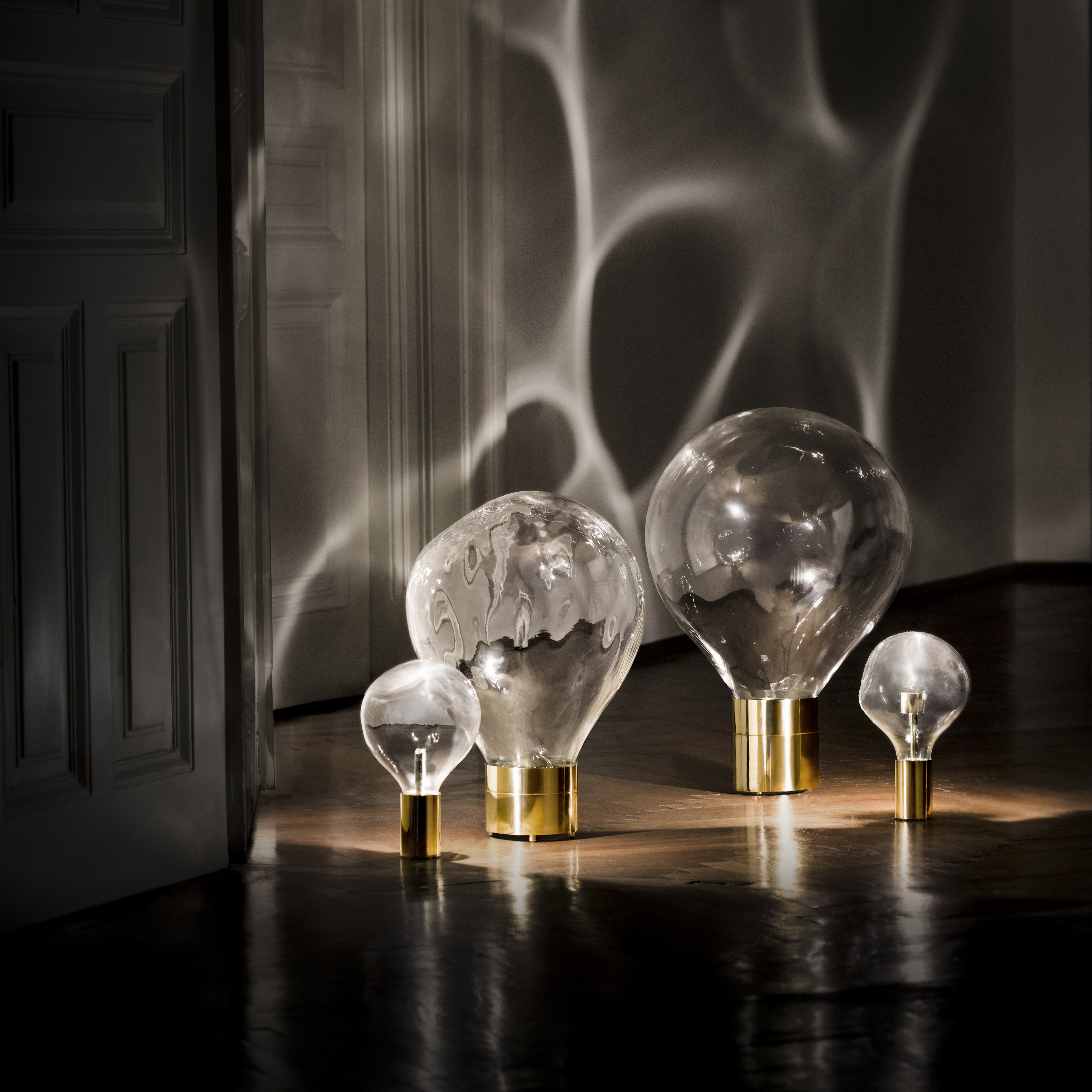 glass art moving lightbulb collection with brass base
