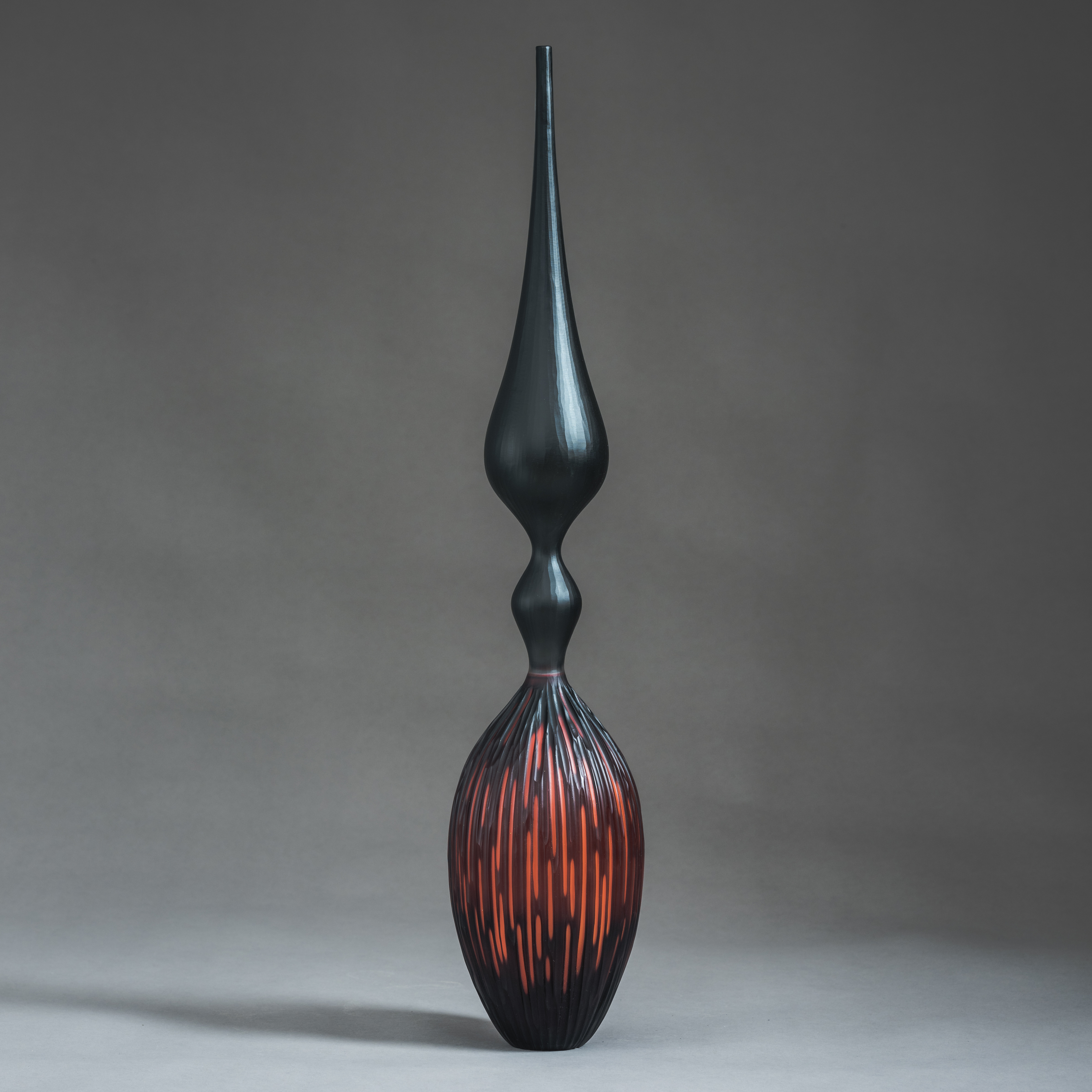 red and black contemporary geometrically patterned sculpture made from handblown and cut glass