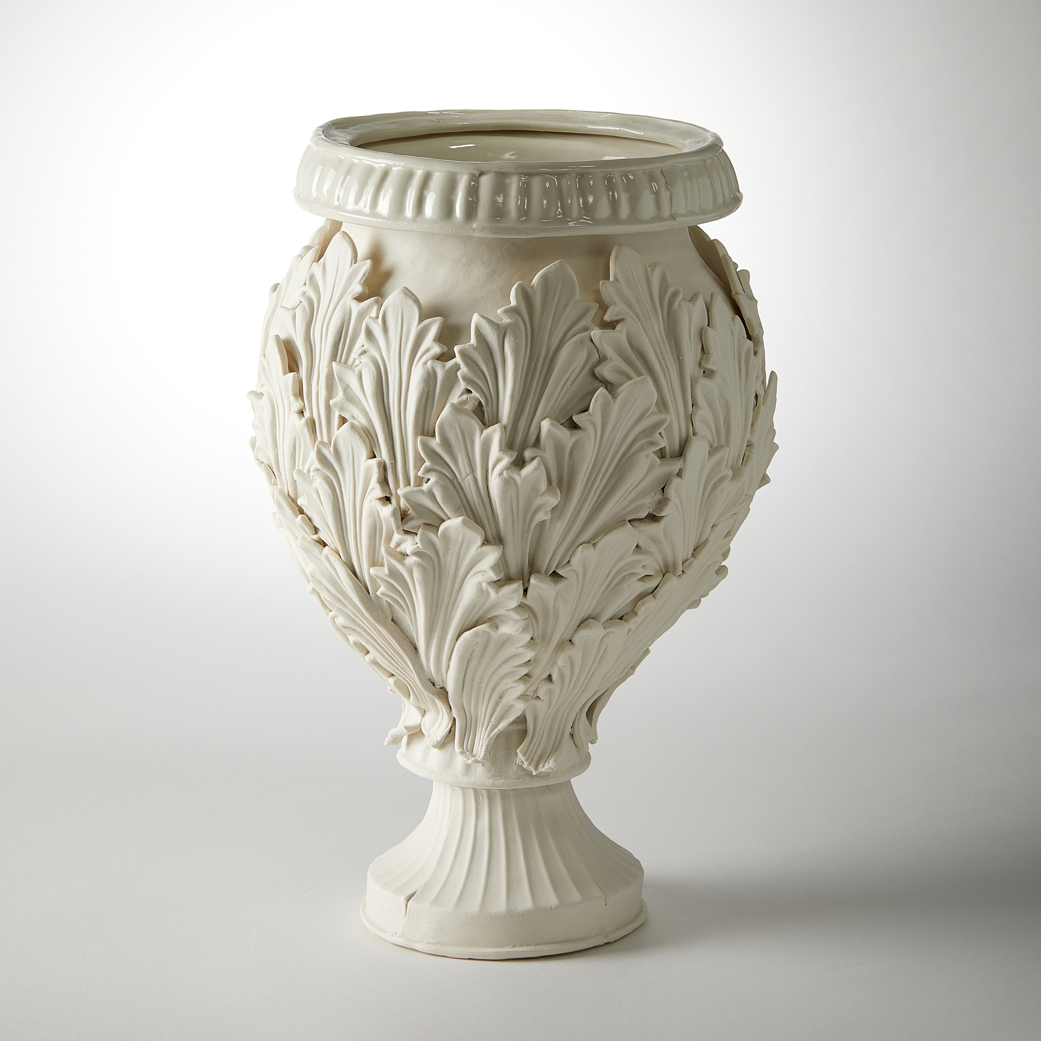 footed ornate vessel with leaf decoration handmade from porcelain