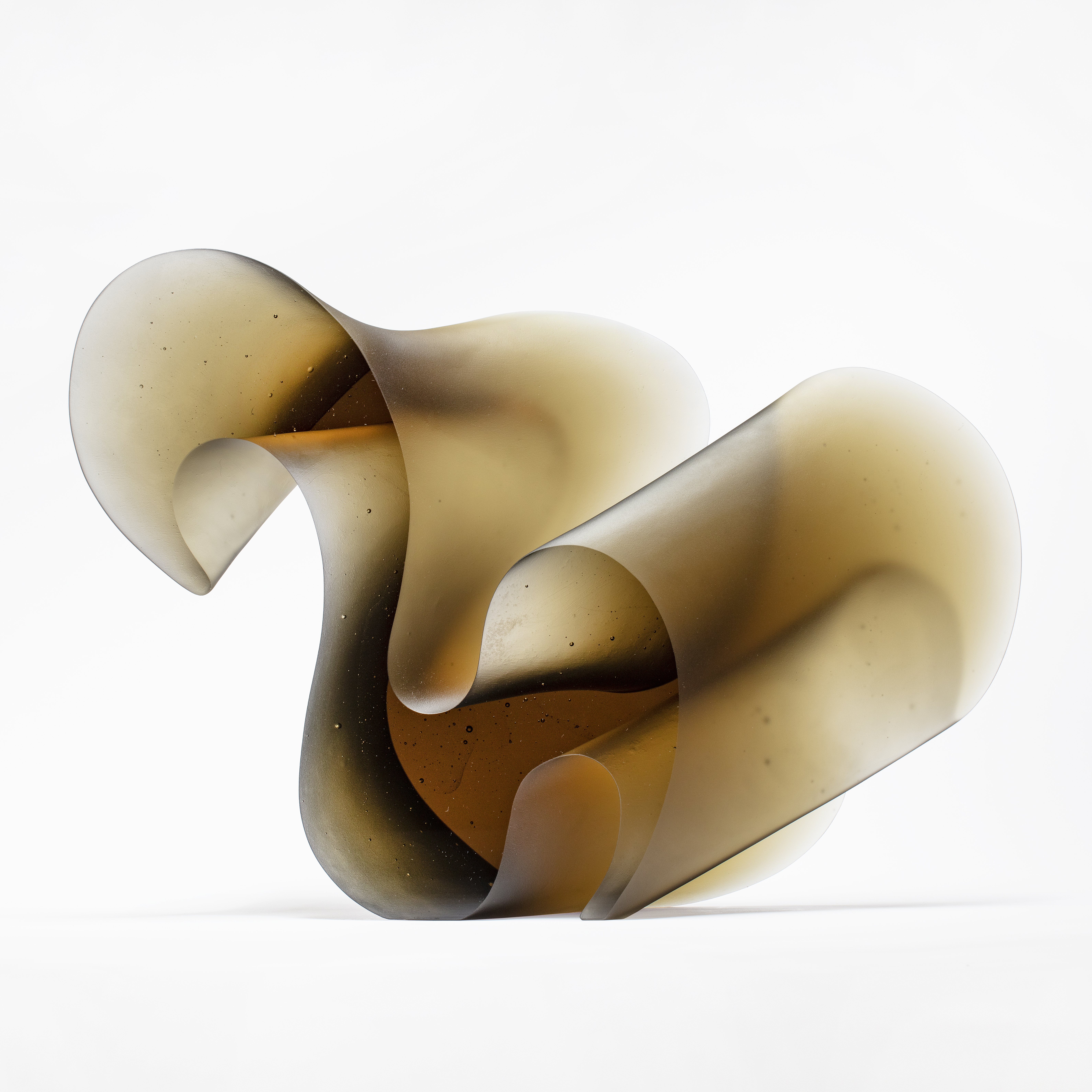bronze brown fluid lined sculpture with dramatic sweeping curves made from cast glass