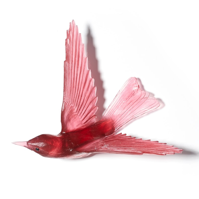 glass sculpture of a bell bird in deep pink