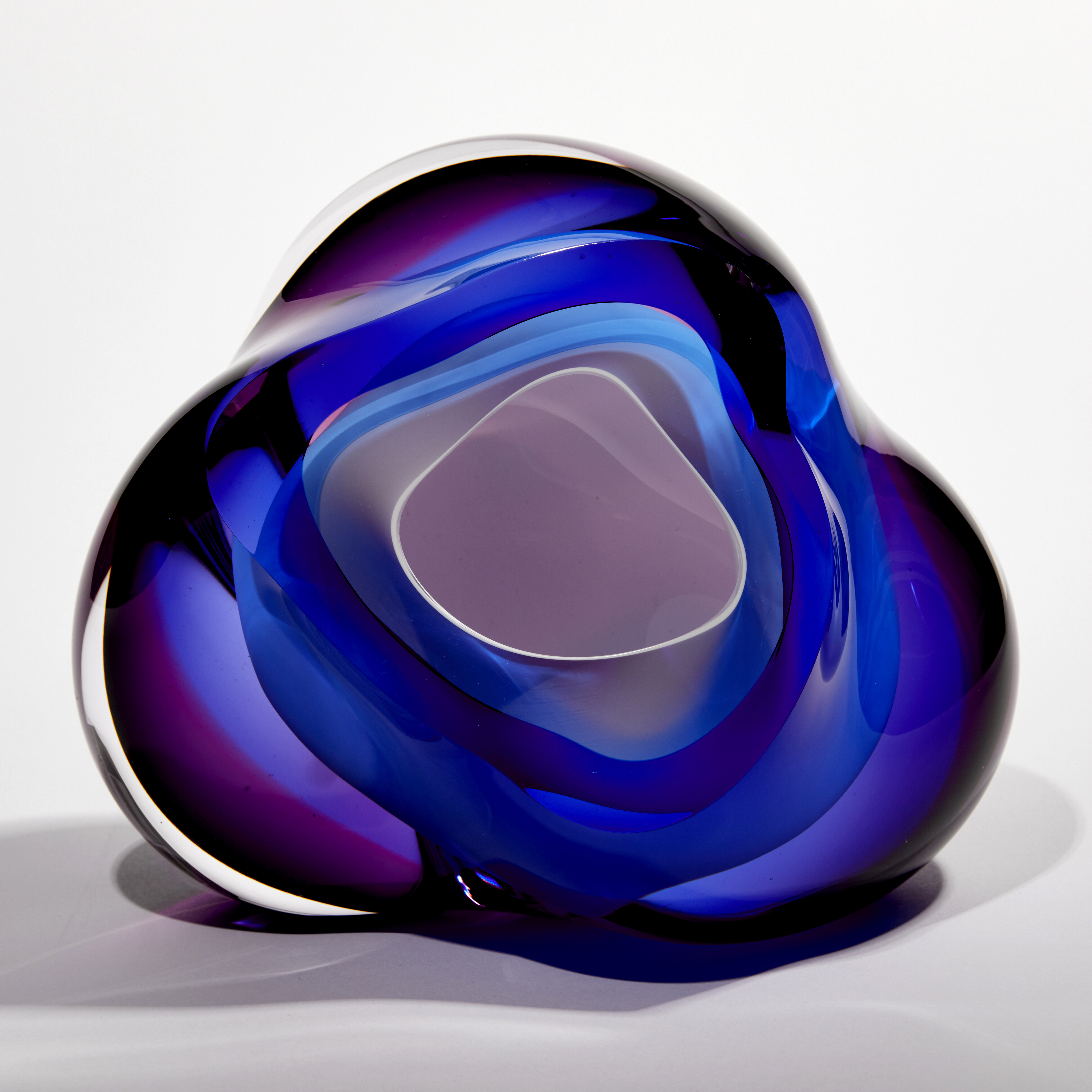 layers of white blue and purple glass create an amorphous handmade sculpture