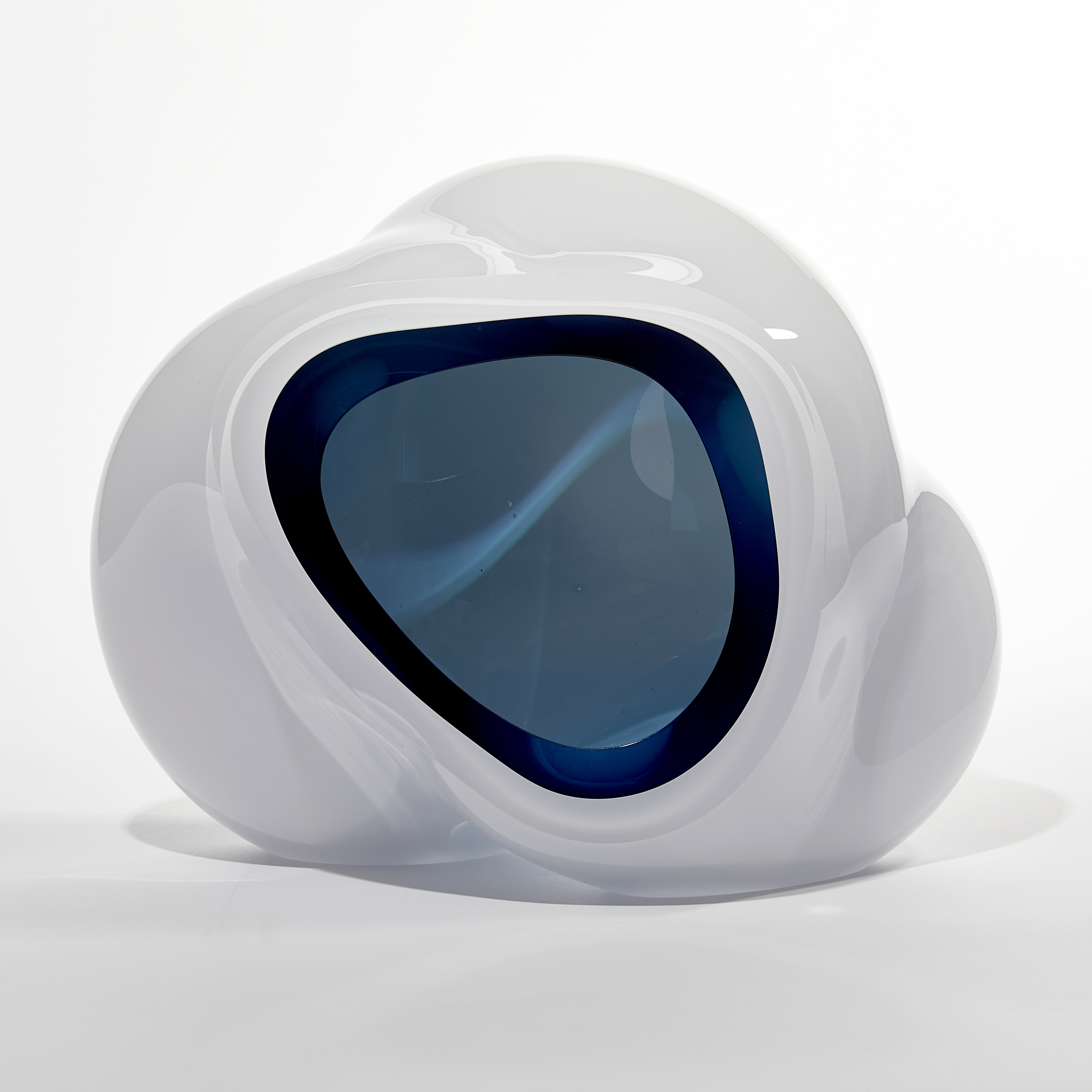 cloud like soft white form with turquoise interior sculpted from blown glass