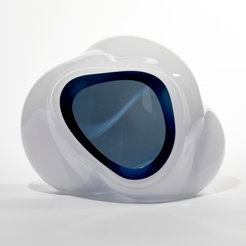 cloud like soft white form with turquoise interior sculpted from blown glass