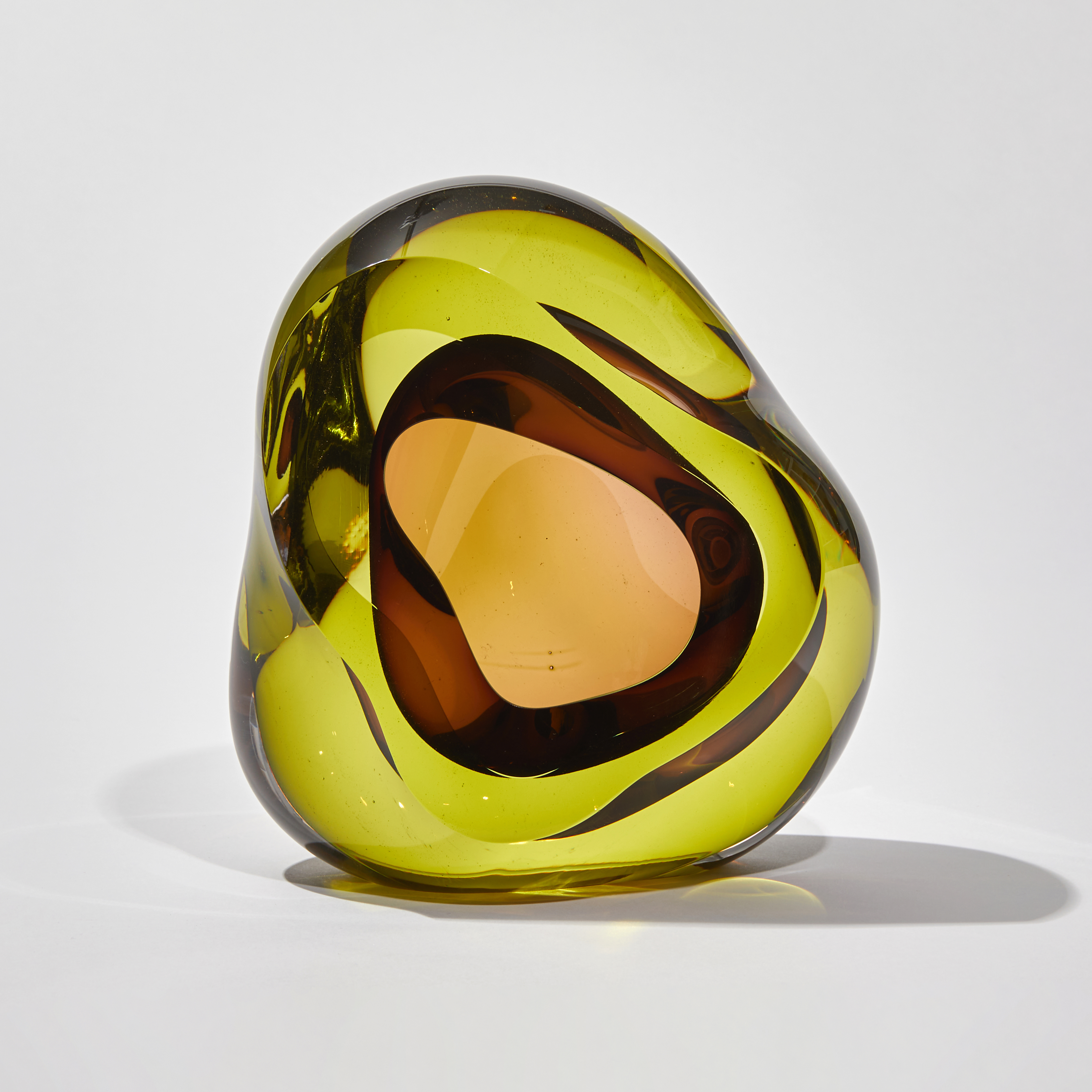 amorphic shaped handmade glass sculpture in lime and purple with centre cavity opening