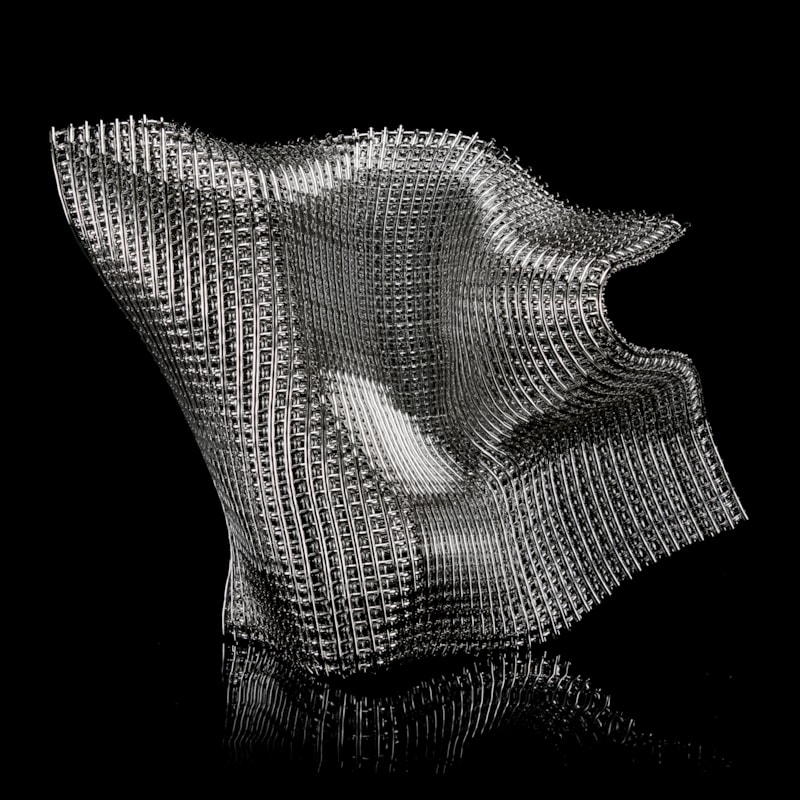 asymmetric organic standing sculpture with the appearance of chunky woven metallic cloth