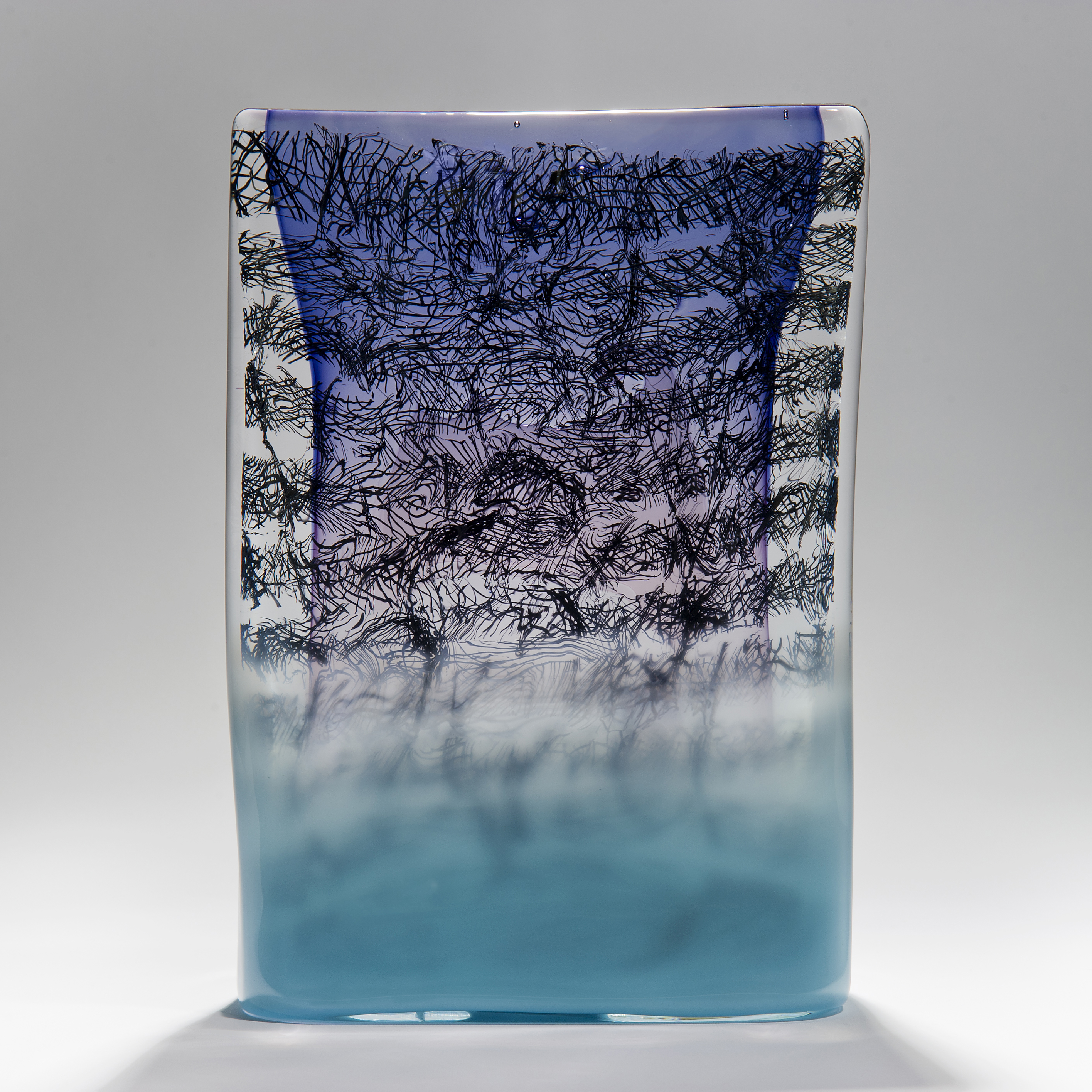 Rectangular standing glass sculpture in purple blue and clear glass with encased scribbled black lines