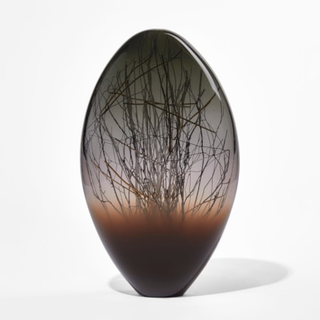 dark brown grey and black ovoid handmade glass sculpture with inner line detail in black and gold