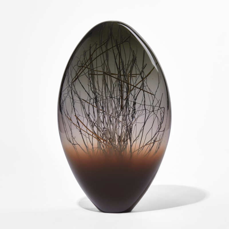dark brown grey and black ovoid handmade glass sculpture with inner line detail in black and gold