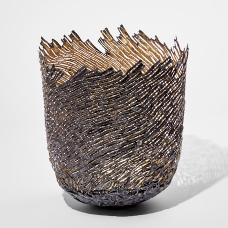 ornamental vessel in black and gold made from steel and precious metals