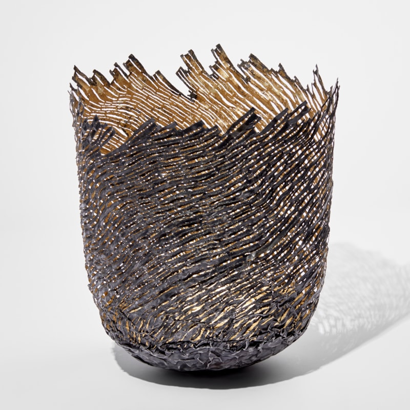 ornamental vessel in black and gold made from steel and precious metals